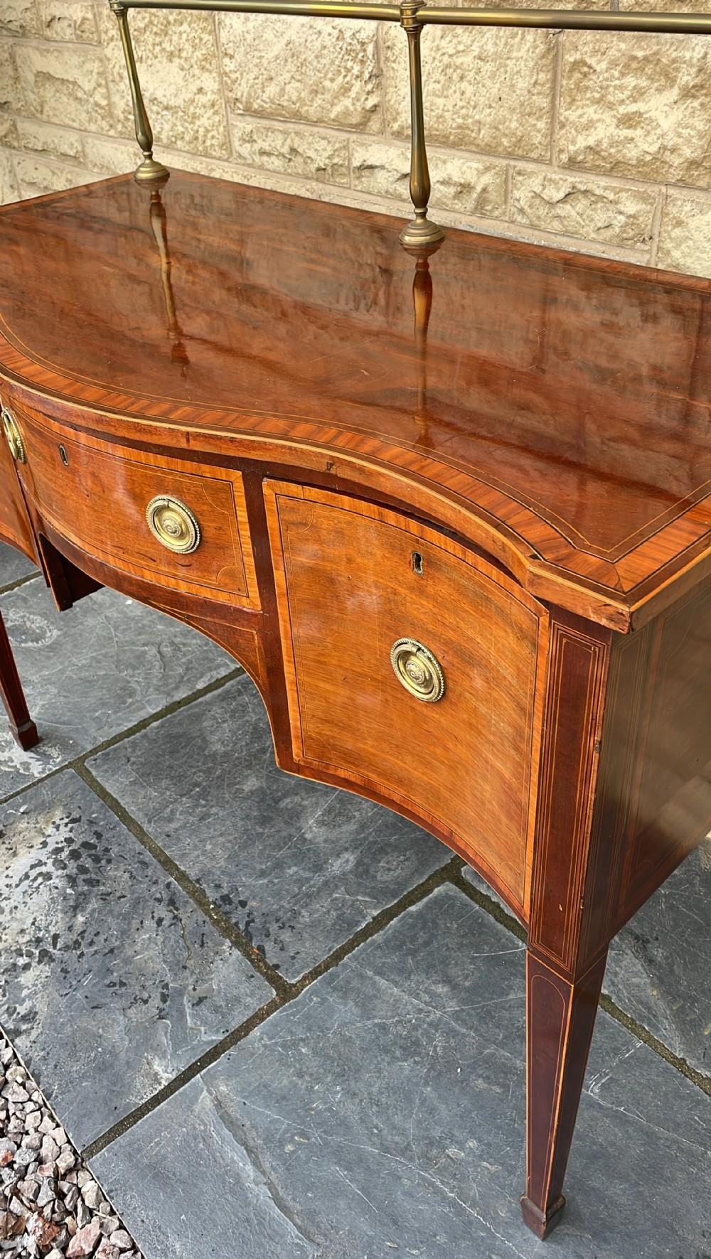 Brass  Early 19th C. English Inlaid Figured Mahogany Hepp. Style Serpentine Sideboard For Sale