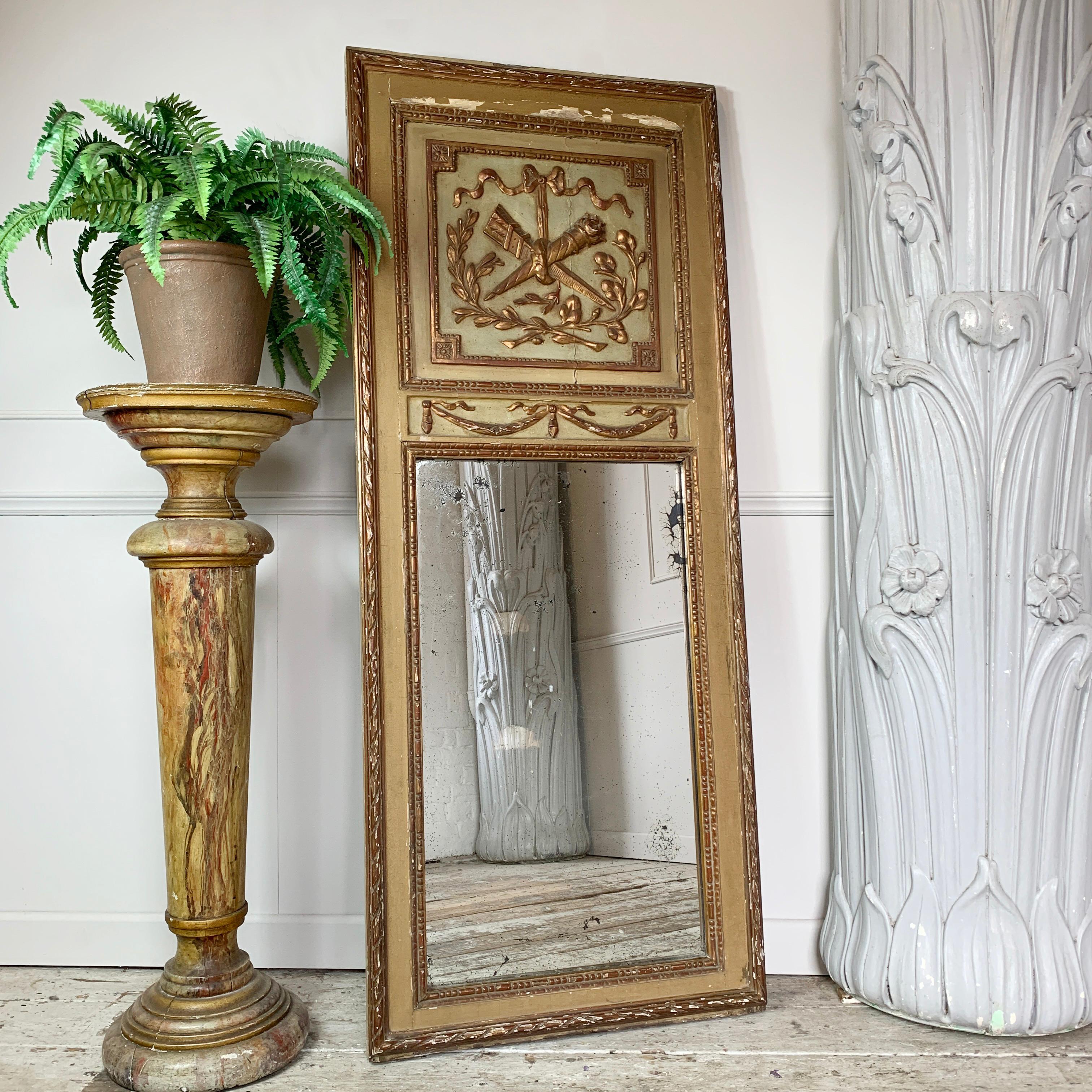 Early 19th c French gilt Trumeau mirror
Fantastic example of a French Trumeau mirror with elegant proportions. The carved wooden frame is overlaid with gesso and gilt, finished in gold and cream tones. 
The cartouche is detailed with the twin