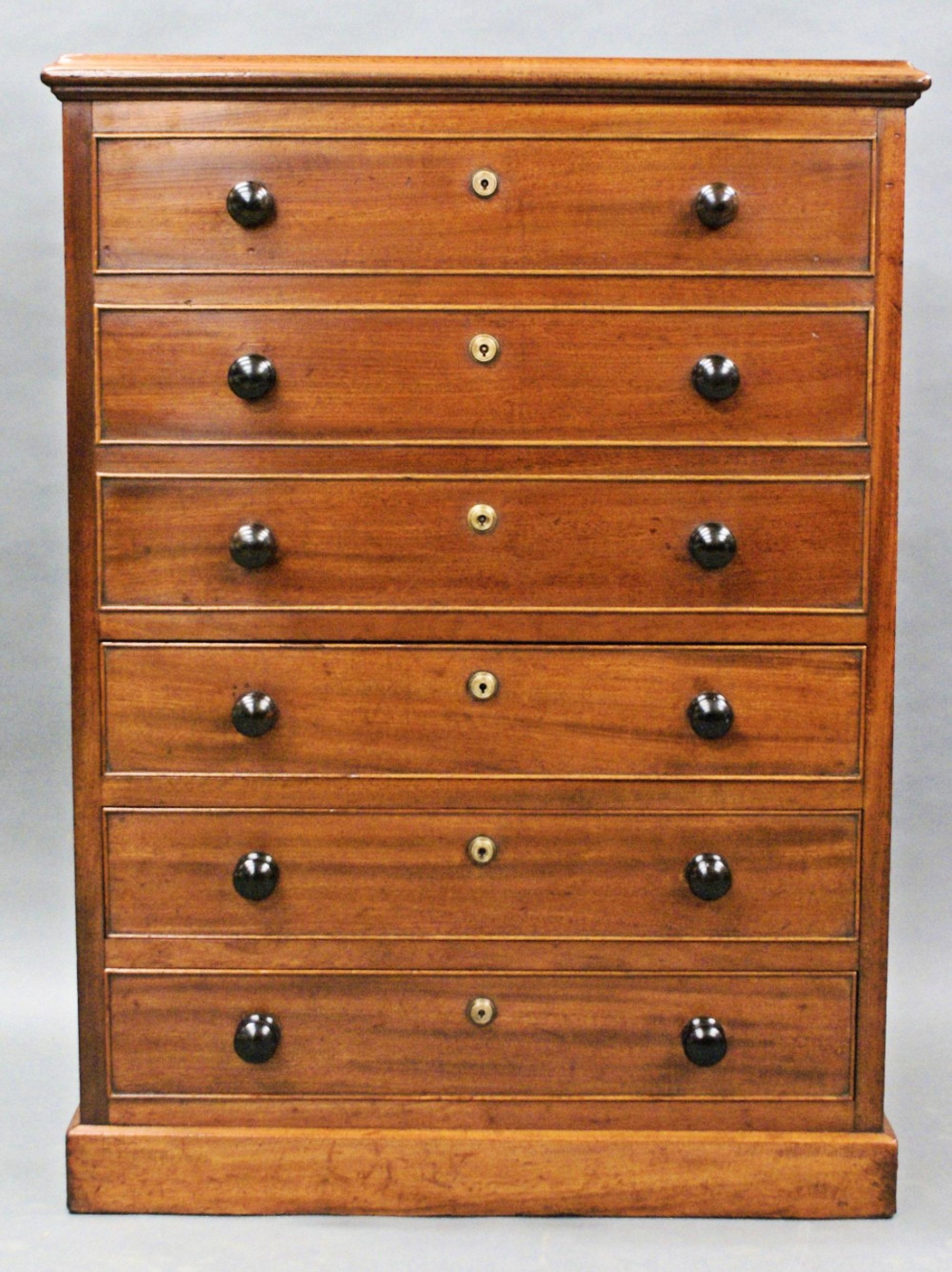 This rare and unusual late Georgian chest of drawers feature 3 bottom oak lined drawers with 3 false drawers on the top portion to house a storage box that opens from the top. The unit has all its original knobs and hardware, and is also finished