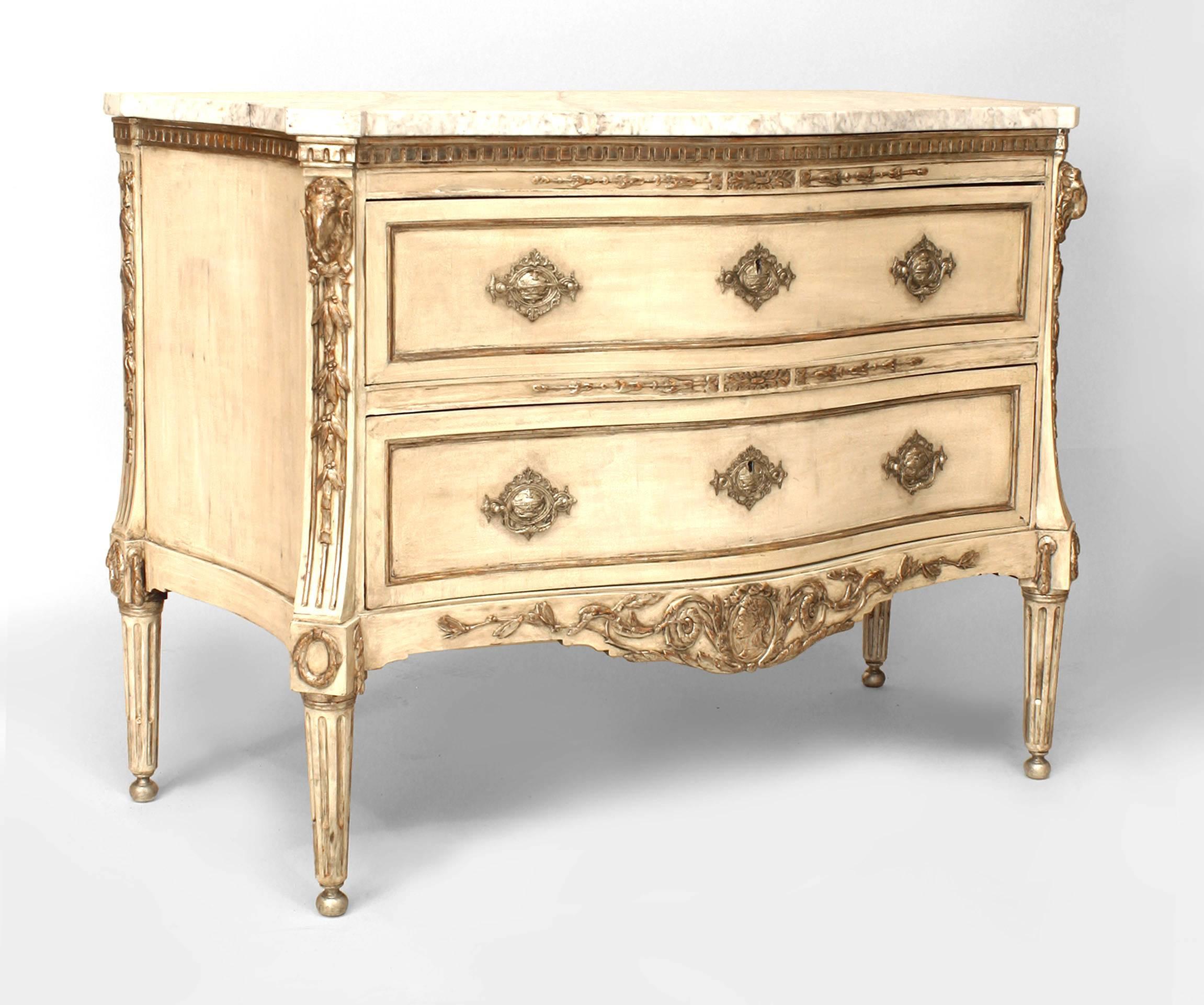 Continental Neoclassic (early 19th Century) painted and silver gilt commode with a serpentine Carrara marble top over two drawers flanked by molded edges with rams heads and bell flowers supported by fluted tapering legs.
