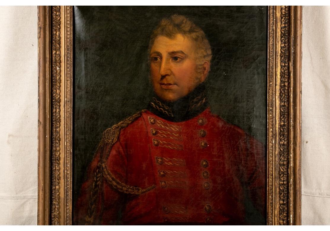 Antique portrait of a handsome senior military officer wearing a red jacket with gold braid over his right shoulder and gold embroidery on the jacket front, with a black gilt embroidered stand up collar. He looks to the left with light shining on