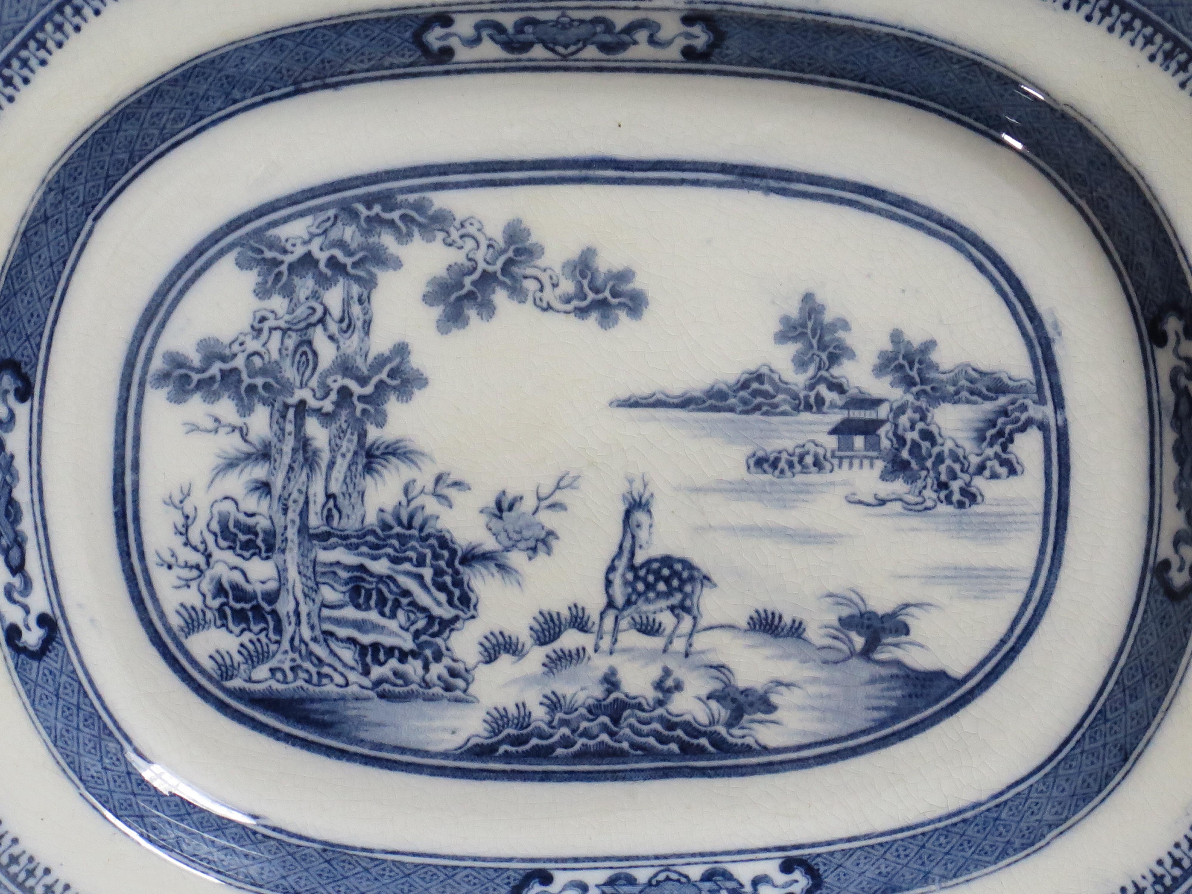 This is a good transfer printed blue and white Dish or Plate, made of a type of earthenware pottery called pearlware, in the early 19th century, that we attribute to a Staffordshire Potteries maker, circa 1820.

The landscape pattern has an