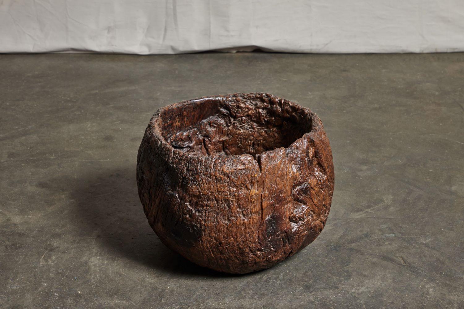 An antique granary mortar bowl in teak hardwood burl. From rural Java, Indonesia, circa early 19th century. Shows a poetic overall erosion pattern and patina.