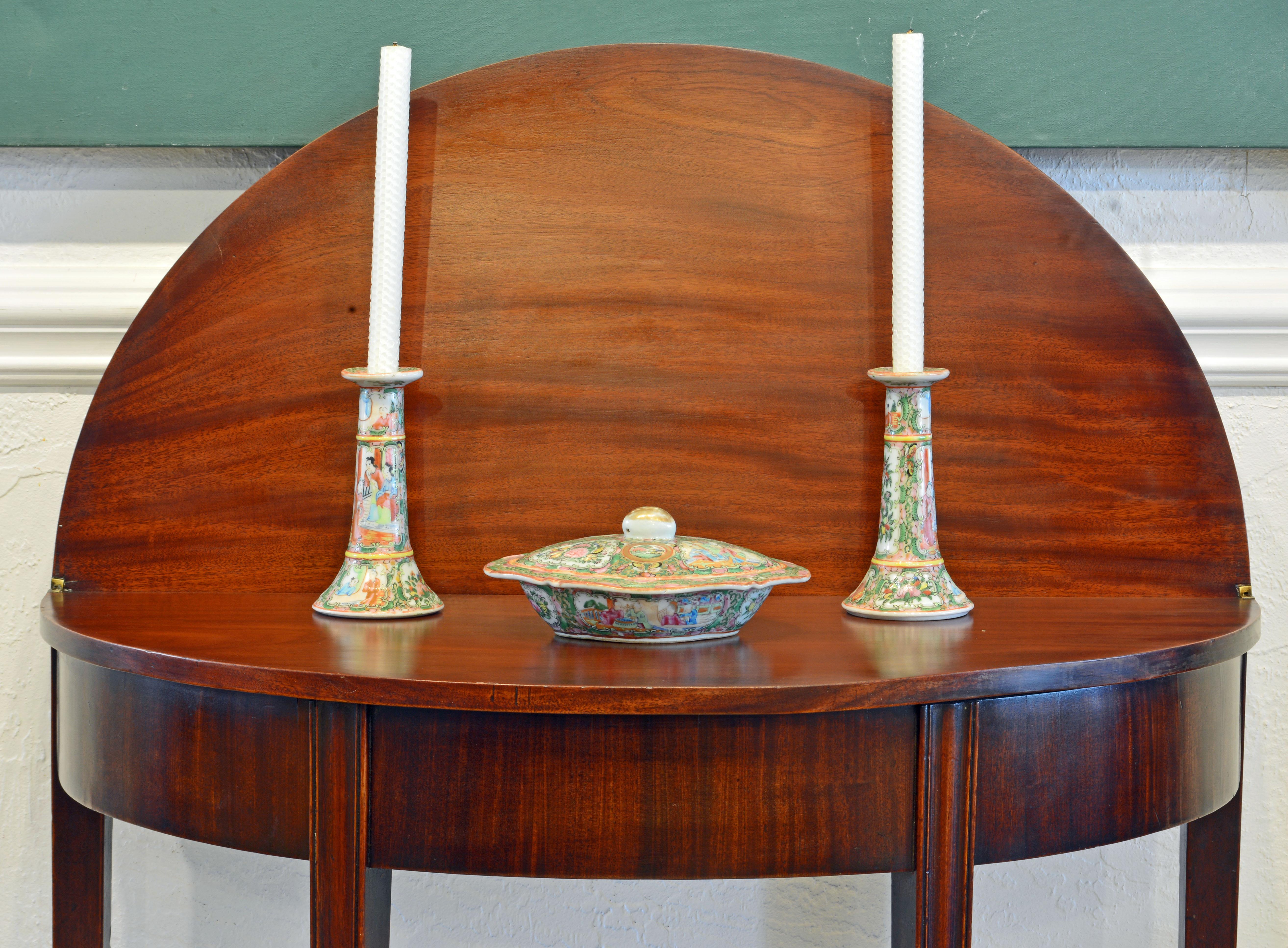 This distinguished Georgian game table is made of the very best mahogany and features a folding top that opens up to a circular table. With the top half open and leaning against a wall a beautiful display area is created. The table rests on four