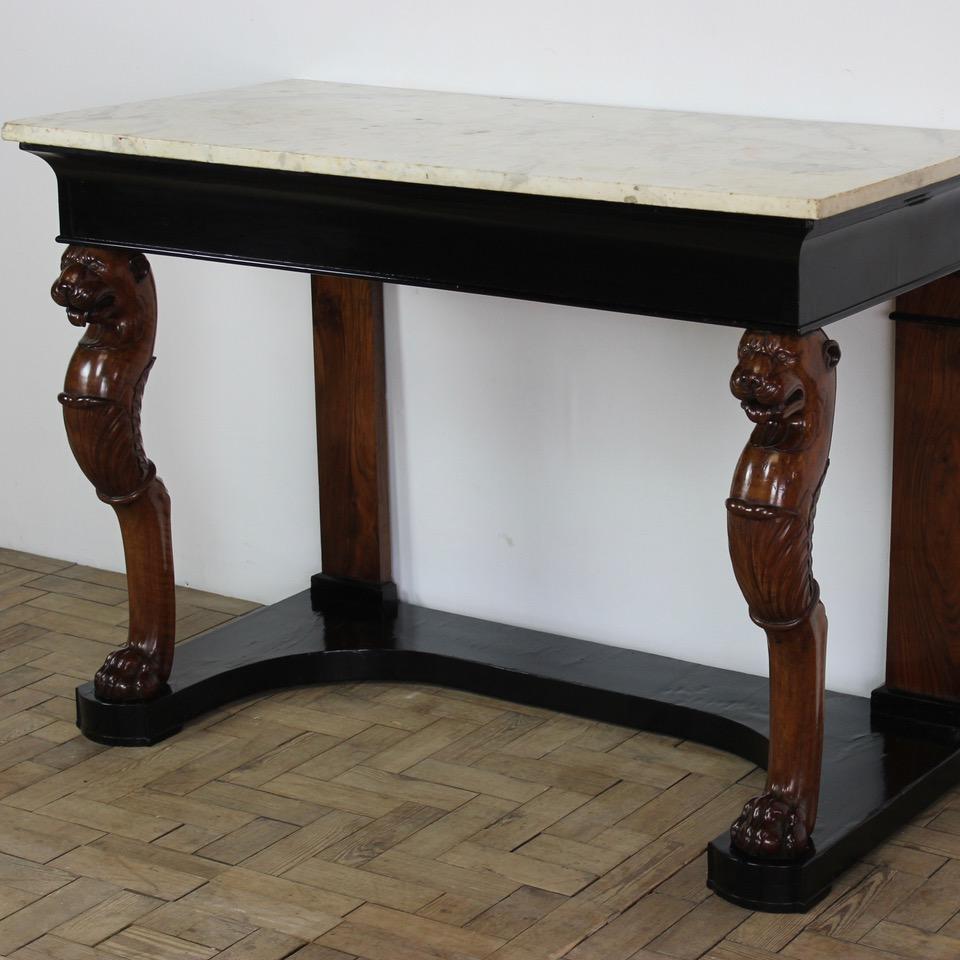 A good quality and of substantial proportions, early 19th century Italian walnut console table retaining the original marble top, and monopodia lions, with later ebonized frieze and base, that will make a statement in most settings.
Great quality