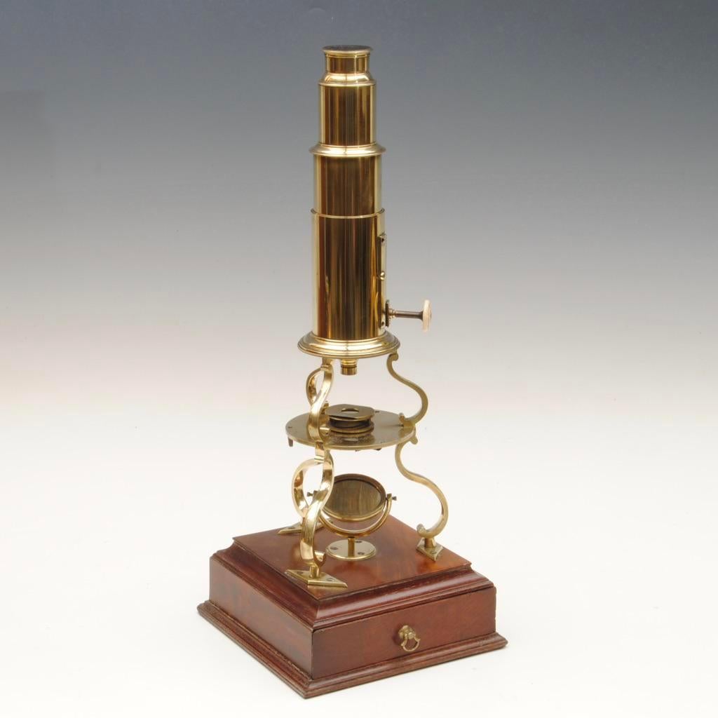 An early 19th century brass culpepper type microscope by Abrahams of Bath in the original mahogany case. The base of the microscope with a fitted drawer containing extra lenses and accessories.
   