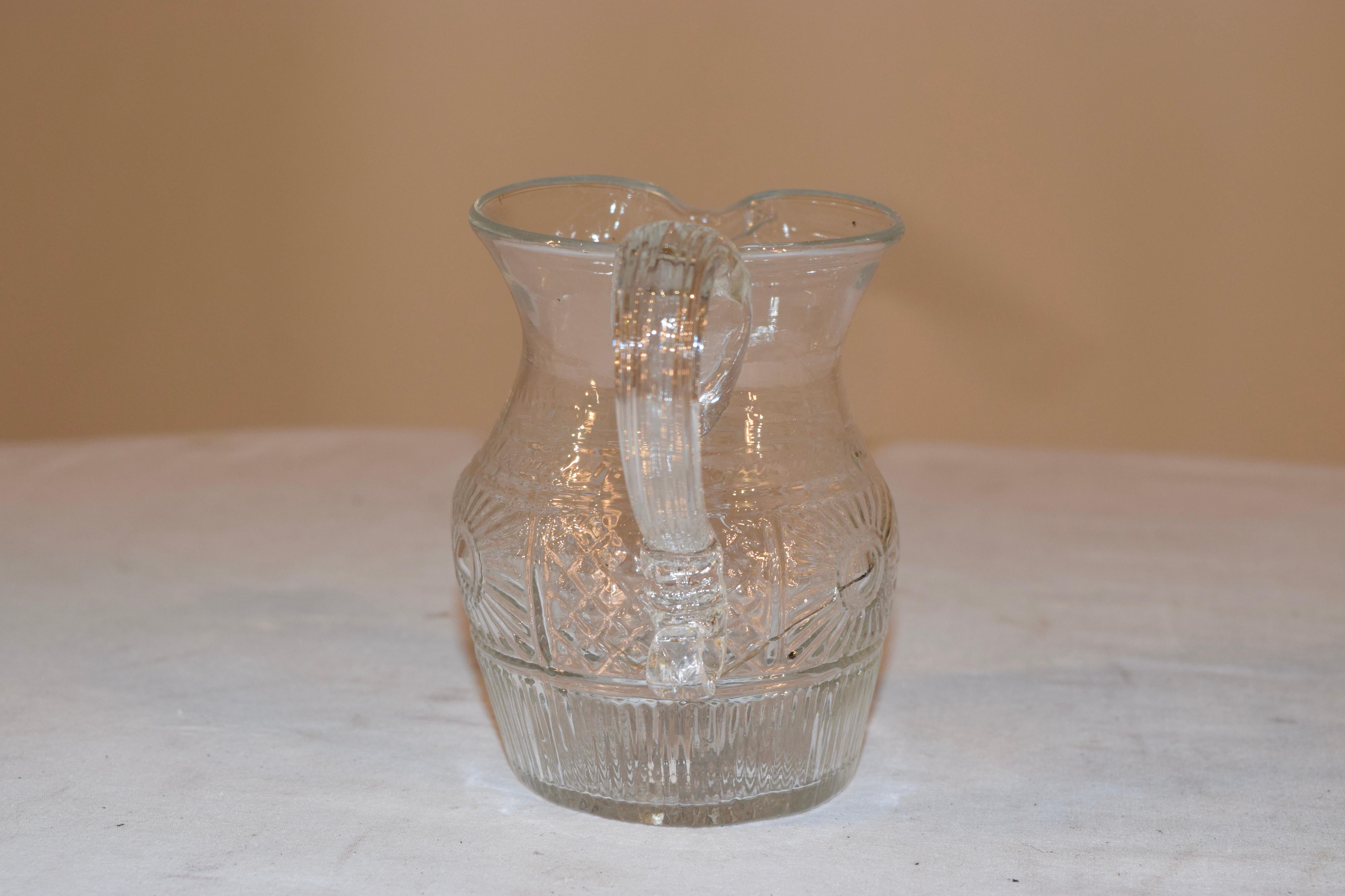 Early 19th century American blown glass pitcher with applied handle.
