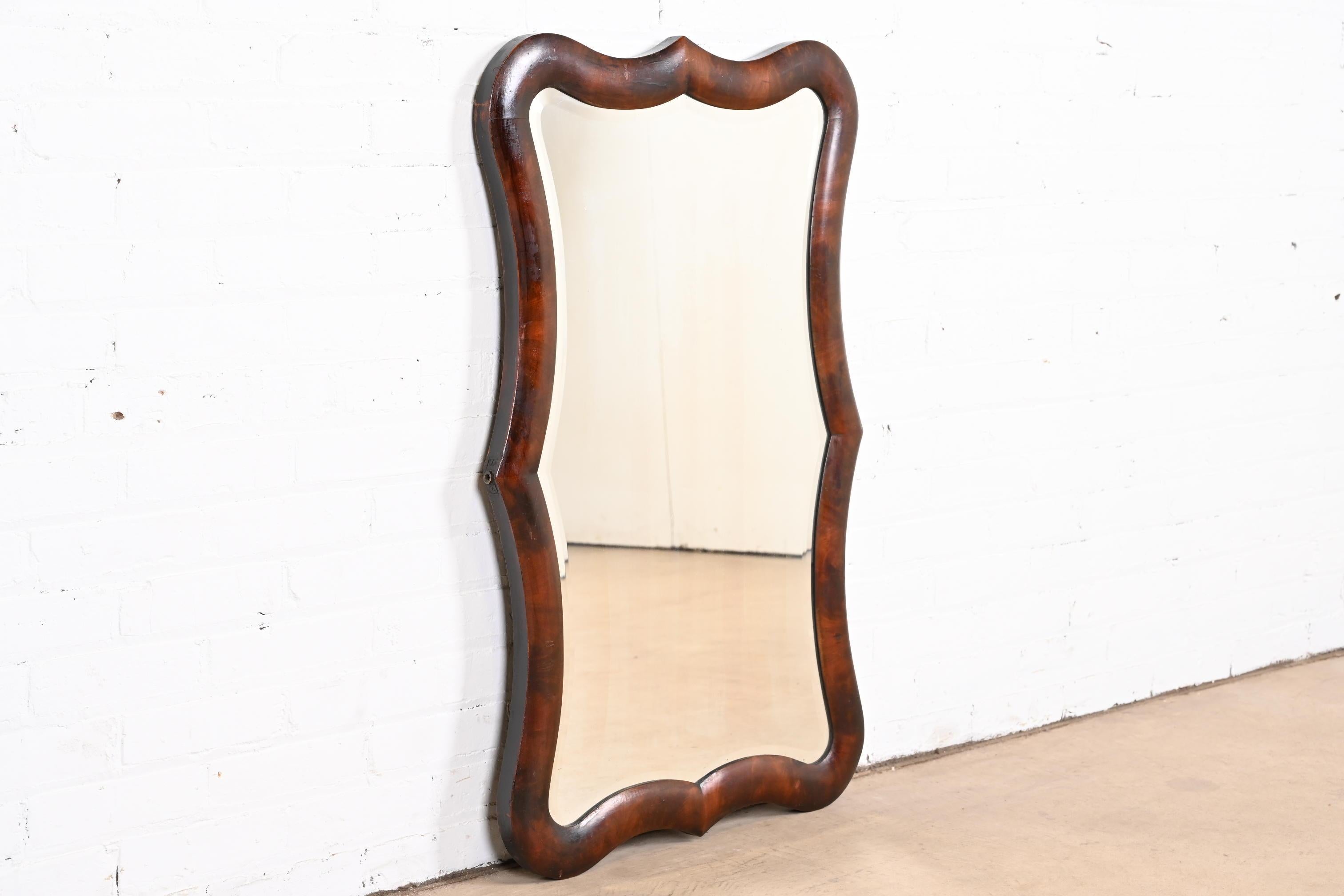 A gorgeous antique American Empire flame mahogany framed beveled wall mirror

Previously sold by Sotheby's Auction in Chicago

USA, Circa 1820s

Measures: 24.25