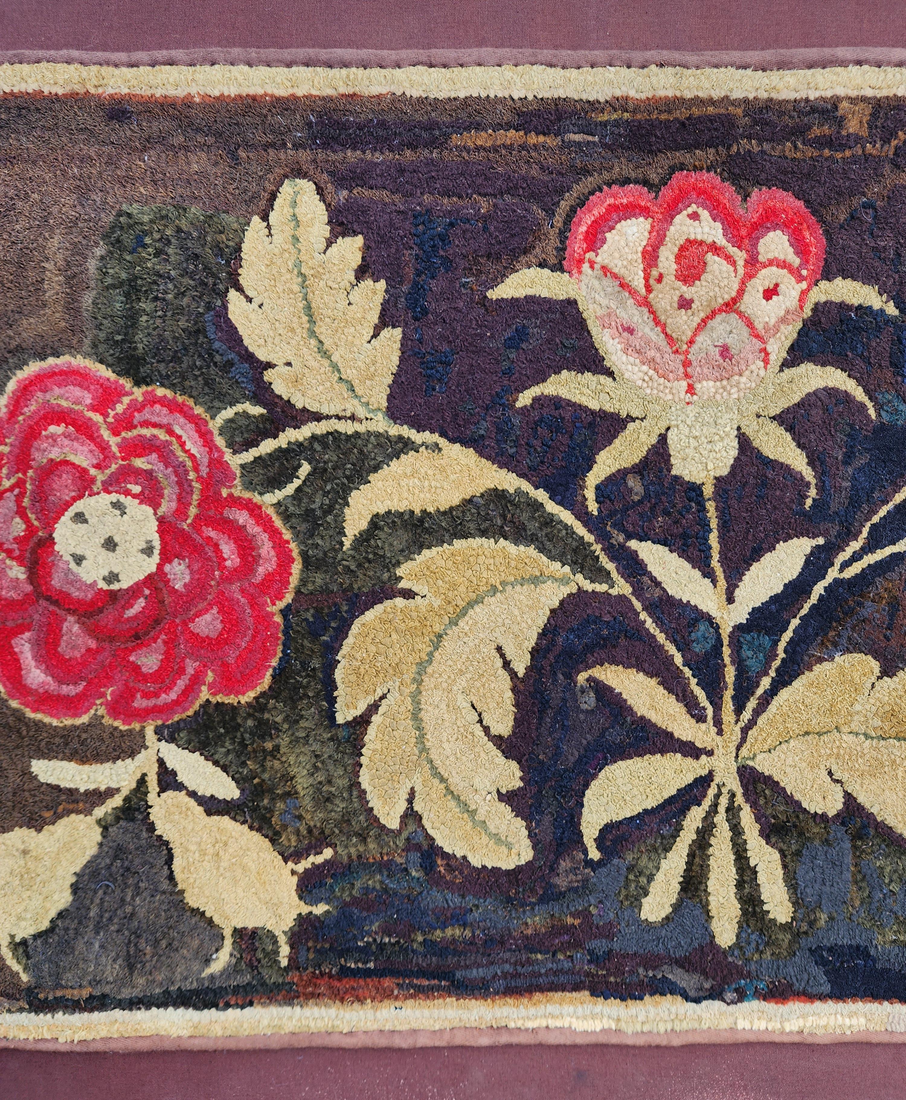 Folk art hand shirred and hooked rug in wonderful colors on a black mottled background. Wool on linen, American, New England circa 1830's. The colors of the flowers are perfectly beautiful against the mottled almost Mondrian like black background.