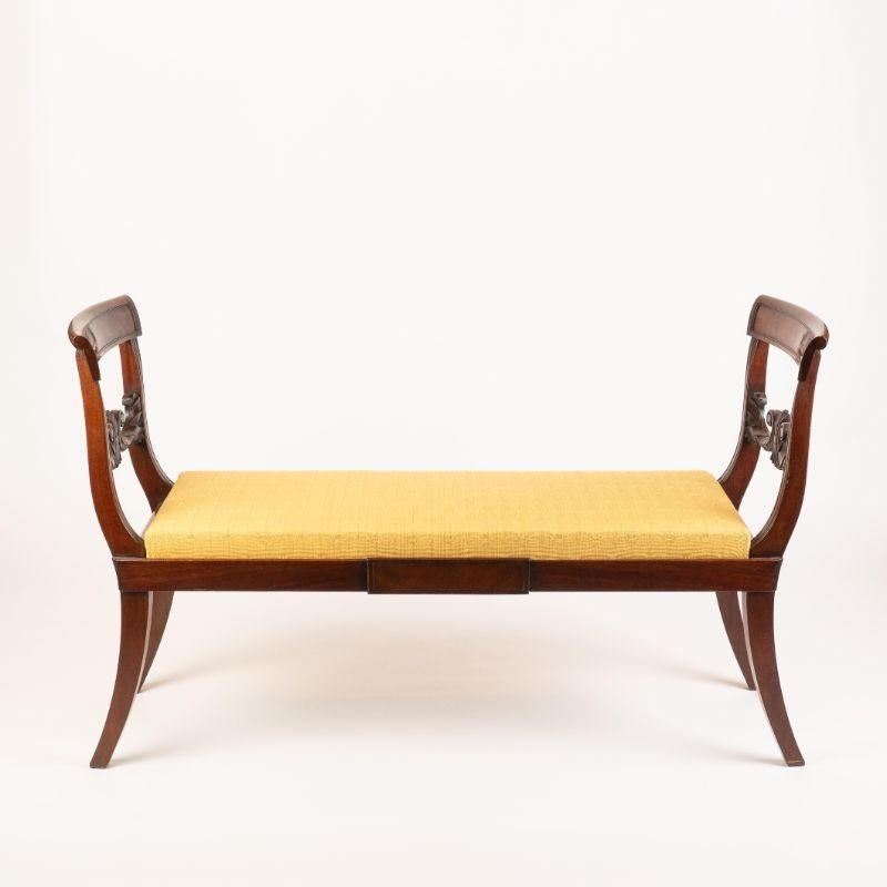 Neoclassic chair back window seat with upholstered box seat in Honduran mahogany. Note the defining carved back rail.
American, New York, circa 1815.