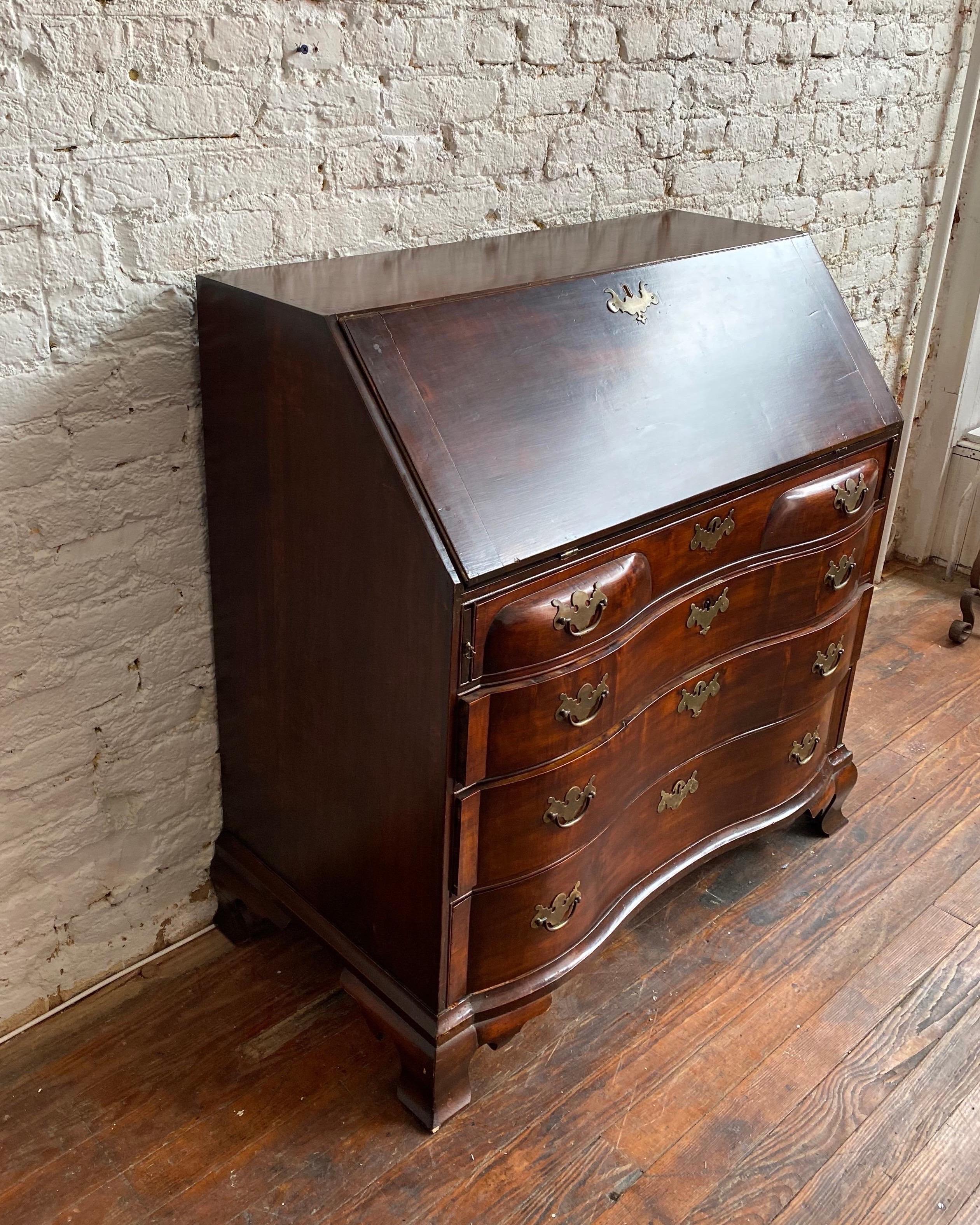 Early 19th century American mahogany slant front desk. Probably Boston, has the blockfront shape that is typical to that area. Nice quality mahogany, exposed dovetails on top and ogee bracket feet.