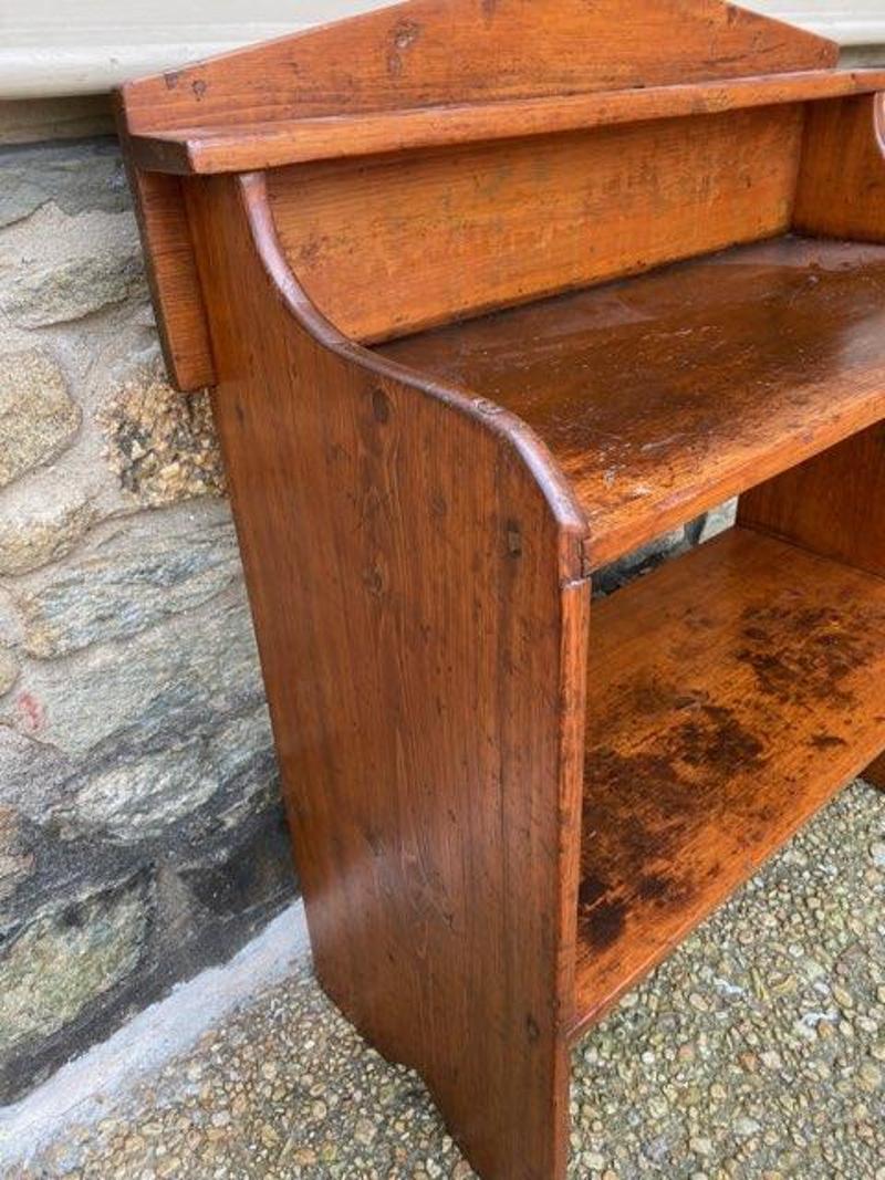 Early 19th Century American Primitive Pine Bucket Bench. Beautifully crafted storage piece typically found on a porch or summer kitchen for keeping well drawn water for easy reach for cleaning dishes and the home or for cooking. 
United States,