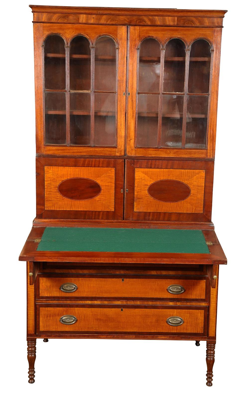 Early 19th century American Sheraton two part secretary of mahogany and tiger maple from coastal new England. Brasses replaced and a few age appropriate cracks. Most panels are original glass, circa 1800-1815.