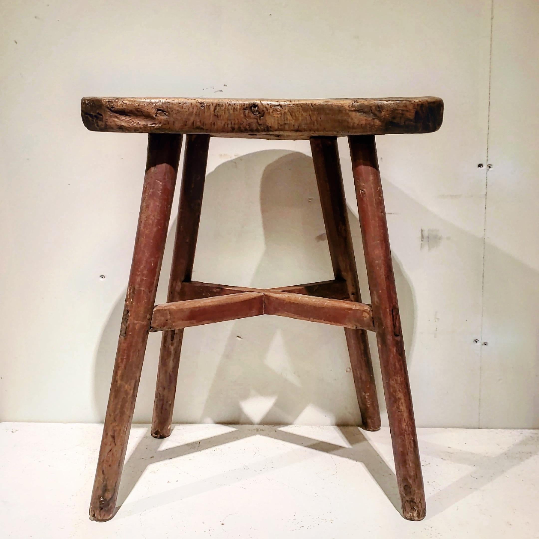 This is a wonderfully folky stool. Found in Pennsylvania. It retains an old, dry red wash on the legs. The seat is made from a sold plank. The entire item is pegged pegged construction.
Great height for a side table.

 