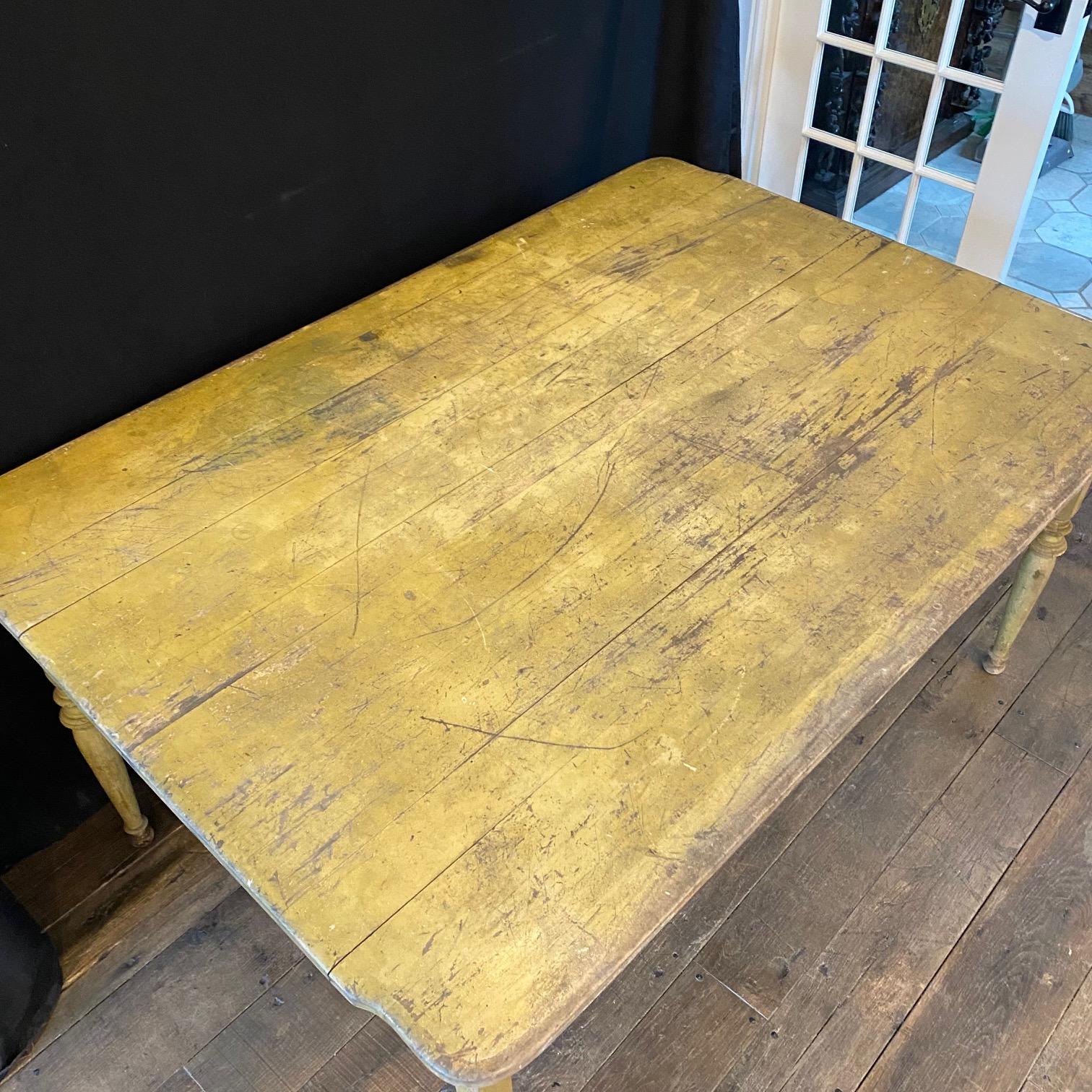 Wonderful primitive antique painted maple farmhouse table having tongue in groove top with curved ends, all supported on early hand turned legs.  Its original yellow milk paint is stunning! Use as a kitchen table, console table, or even a desk. 