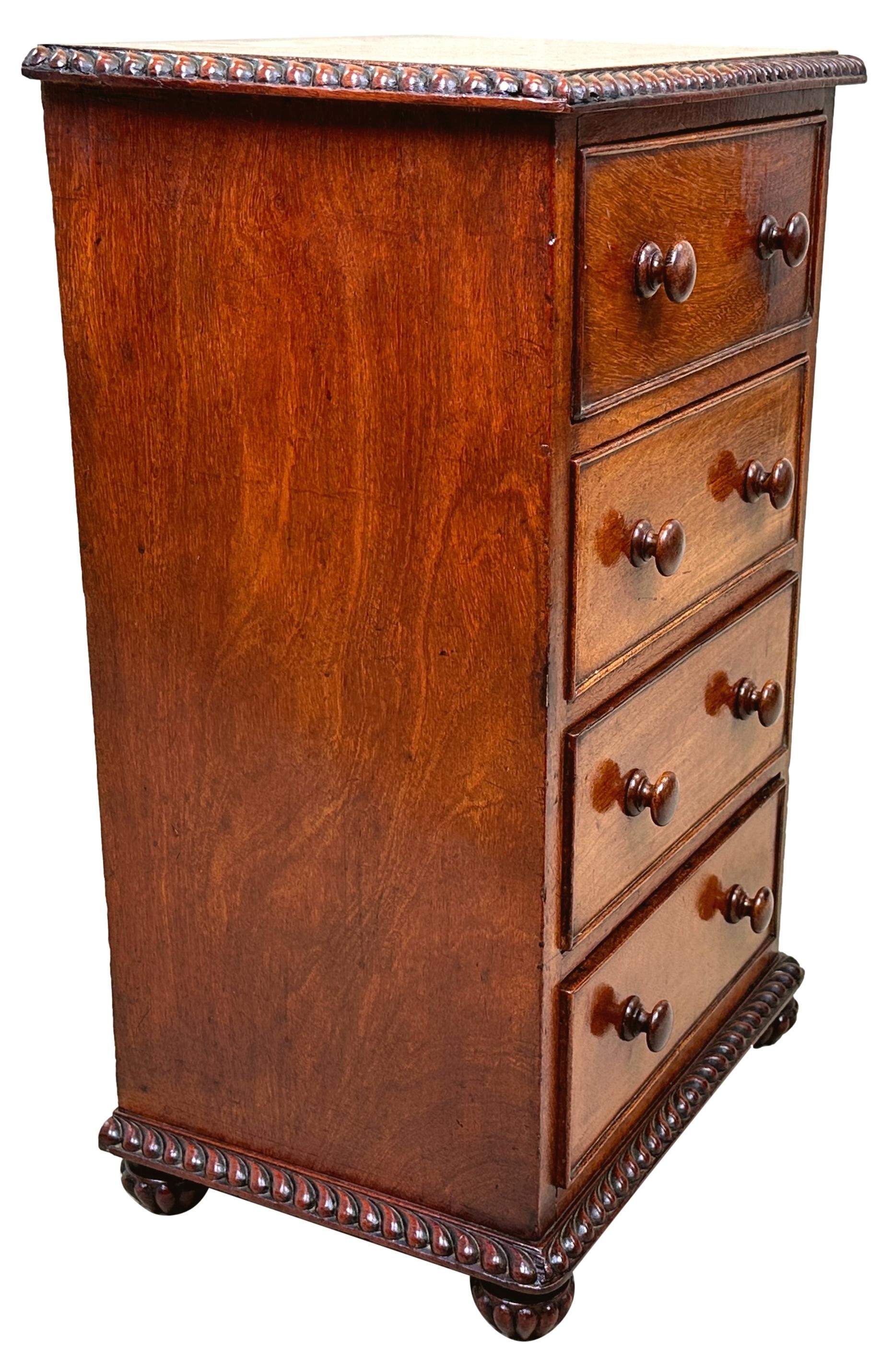 An Attractive And Very Good Quality Anglo-Indian, 19th Century, Padouk Wood Childs Chest, Having Well Figured Rectangular Top With Gadrooned Carving To Edge, Over Four Drawers, Retaining Original Turned Wooden Knobs, Raised On Original Attractive