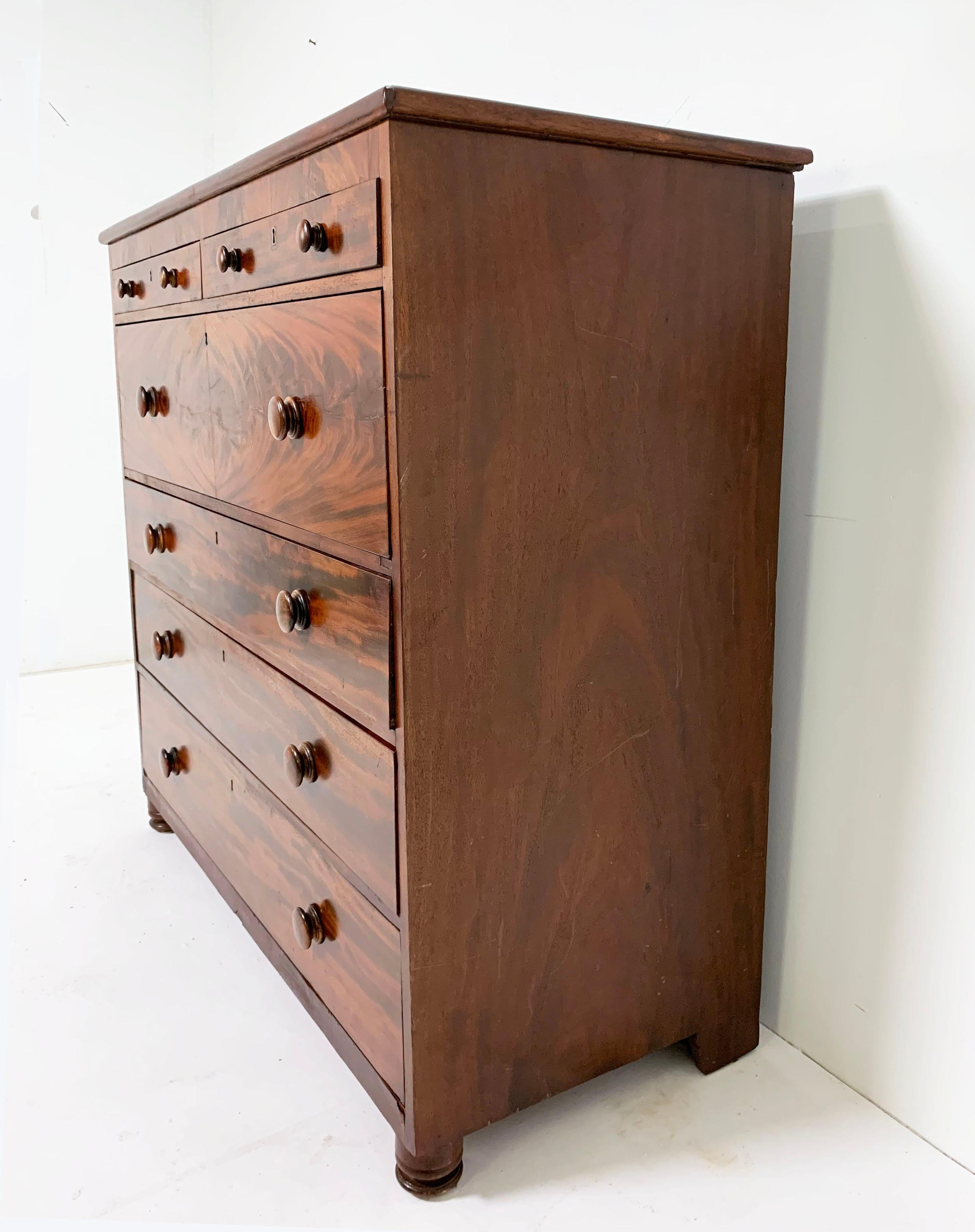 An unusually broad shouldered flamed mahogany dressing chest, early 19th century, likely built just at the cusp of the Federal and Empire periods.
