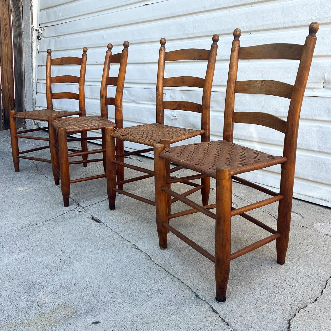 
Introduce the charm of classic American craftsmanship to your dining room with our set of four antique early American Shaker ladderback chairs. Authentic and rich with history, these pieces exemplify the sturdy construction and attention to detail