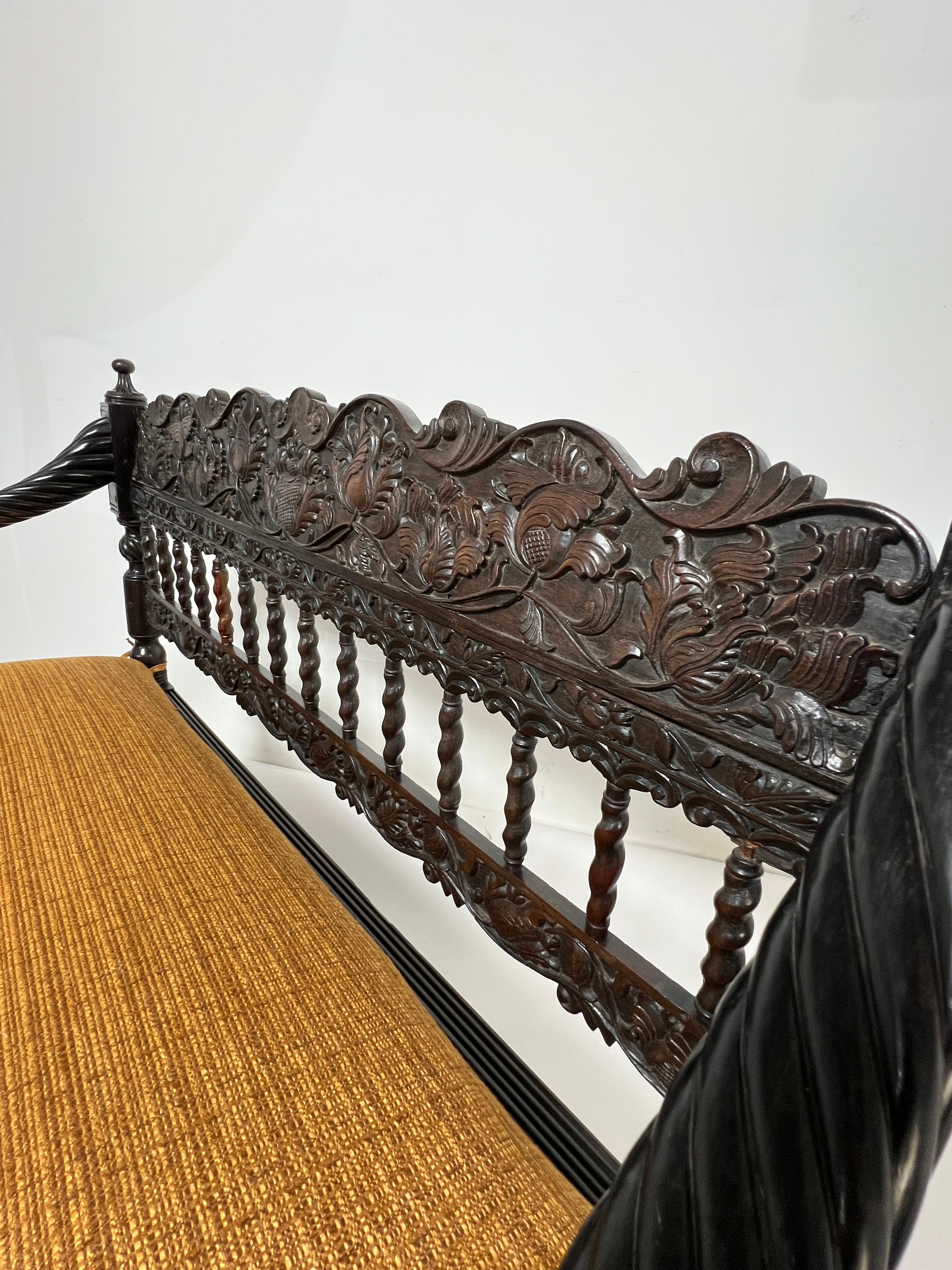 Sri Lankan Early 19th Century Antique Anglo Indian Caned Seat Settee in Carved Ebony For Sale