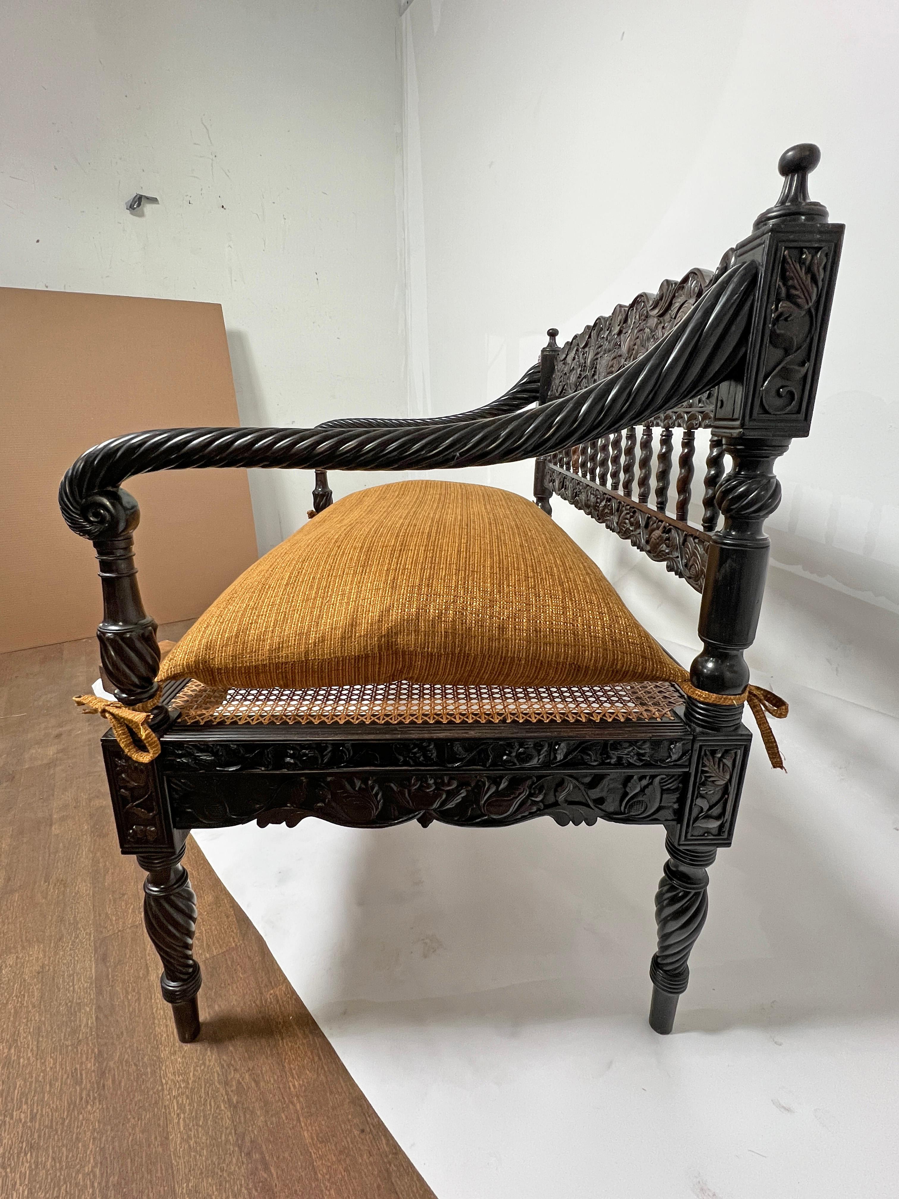 Upholstery Early 19th Century Antique Anglo Indian Caned Seat Settee in Carved Ebony For Sale