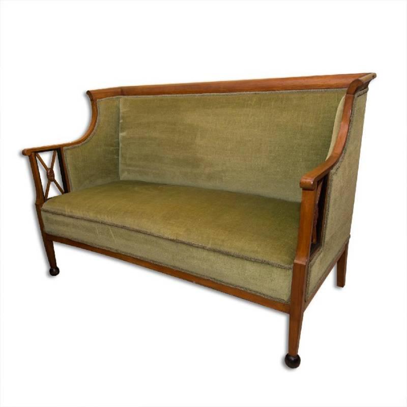 This antique sofa from the Biedermeier period was made circa 1830 in Austria. It features carved walnut veneer and is upholstered with a suede fabric. It is in good condition, it has been renovated in the past.