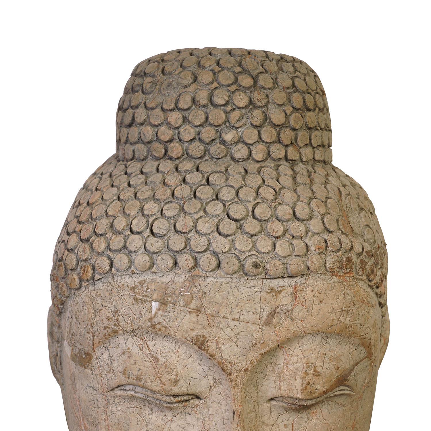 Look at this magnificent Chinese antique carved stone Shakyamuni Buddha Head. It shows very detailed hand carving works on it. With closed eyes and a gentle expression, this large stone Buddha head brings the calm and serenity to its surroundings.