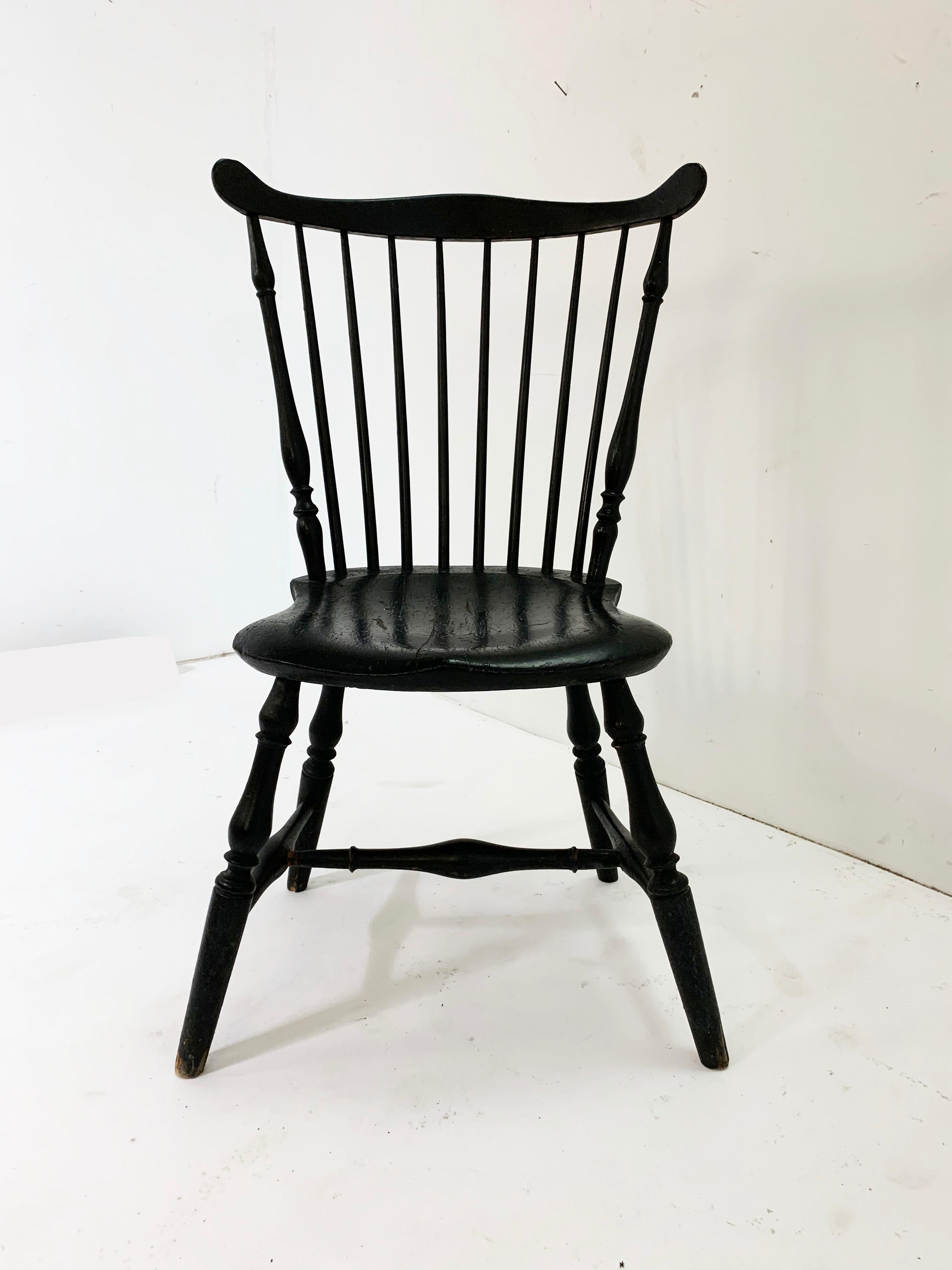 An early 19th comb-back Windsor in original lamp black paint, signed by maker S. Hill, from a Salem, MA collection.