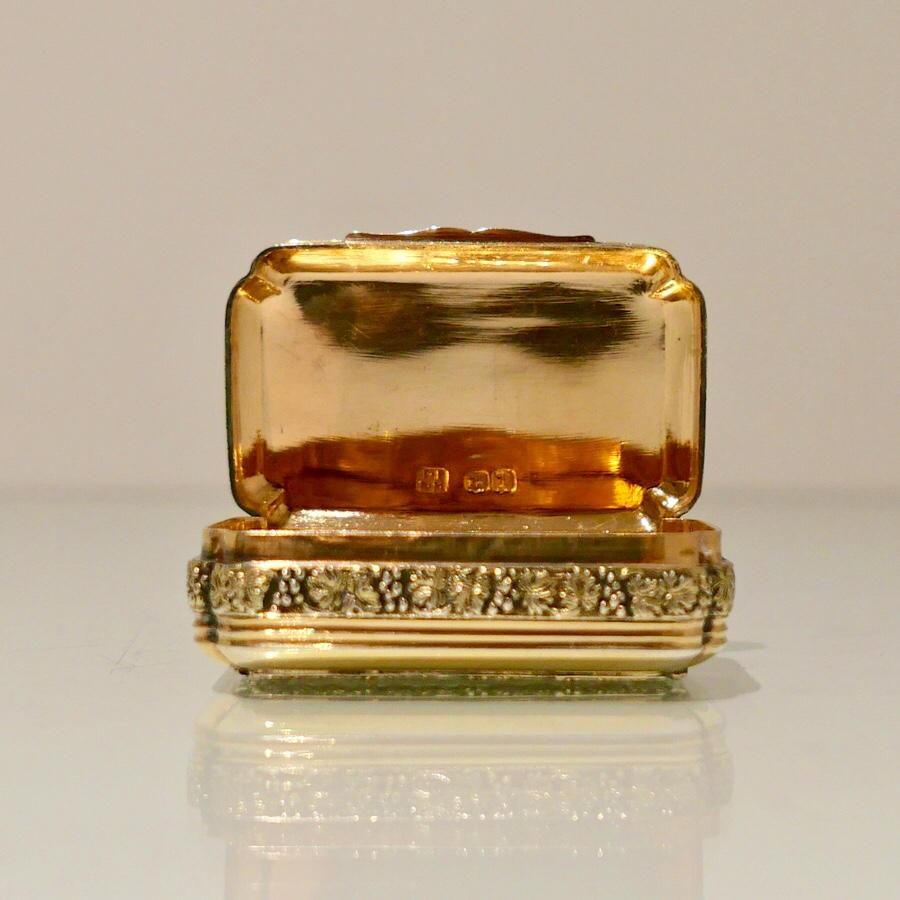 A sweet early 19th century Georgian silver gilt shaped cornered rectangular snuff box design with a hinged lid and decorative grape and vine applied borders.

 

Weight: 1.8 troy ounces/59 grams

Measures: Height 2 inches/5cm
