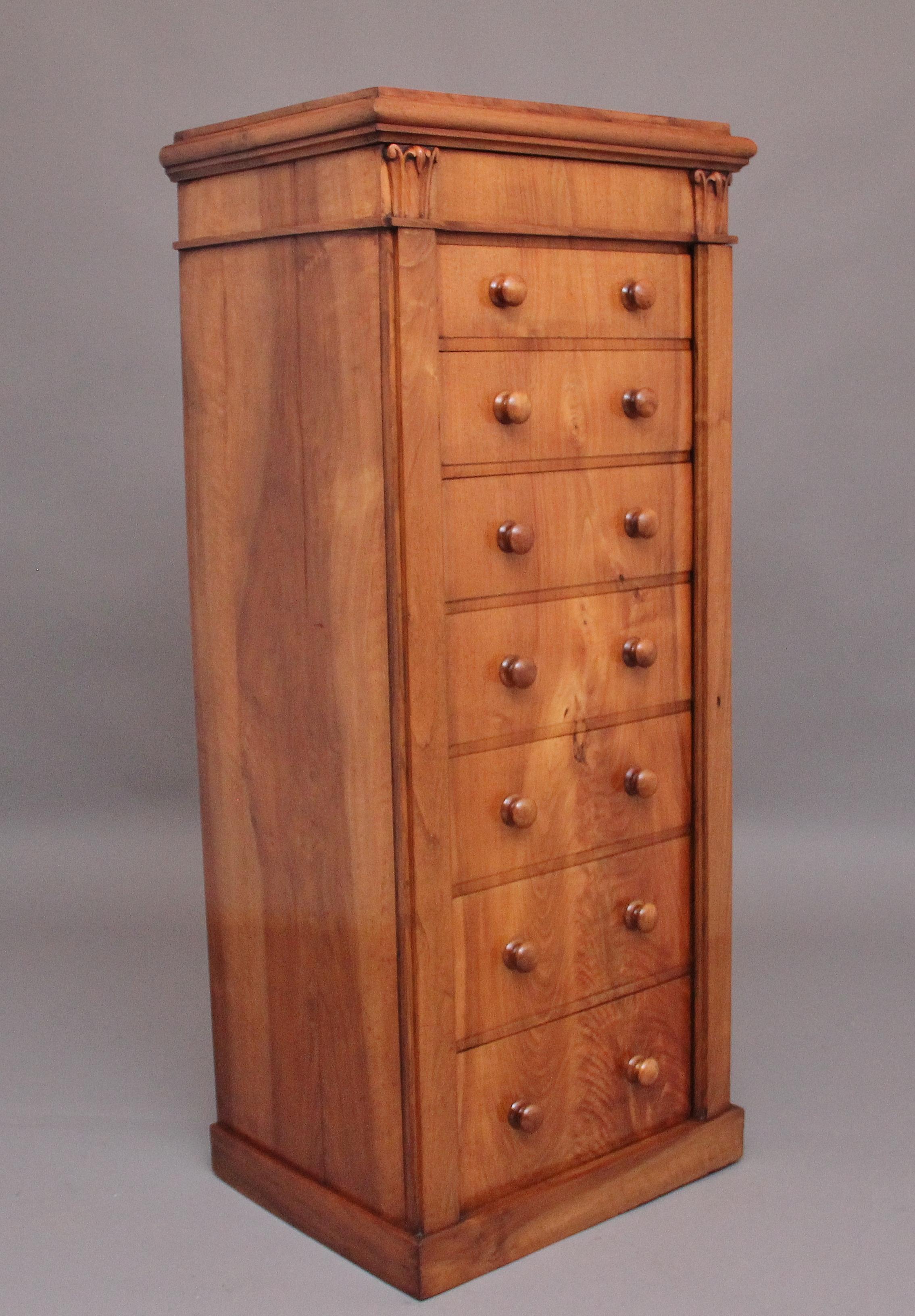 Early 19th Century antique Regency walnut Wellington chest, having a nice figured top sitting above a shaped cornice, the hinged top lifts up to reveal a spacious compartment space, carved tulip decoration underneath either side, a selection of