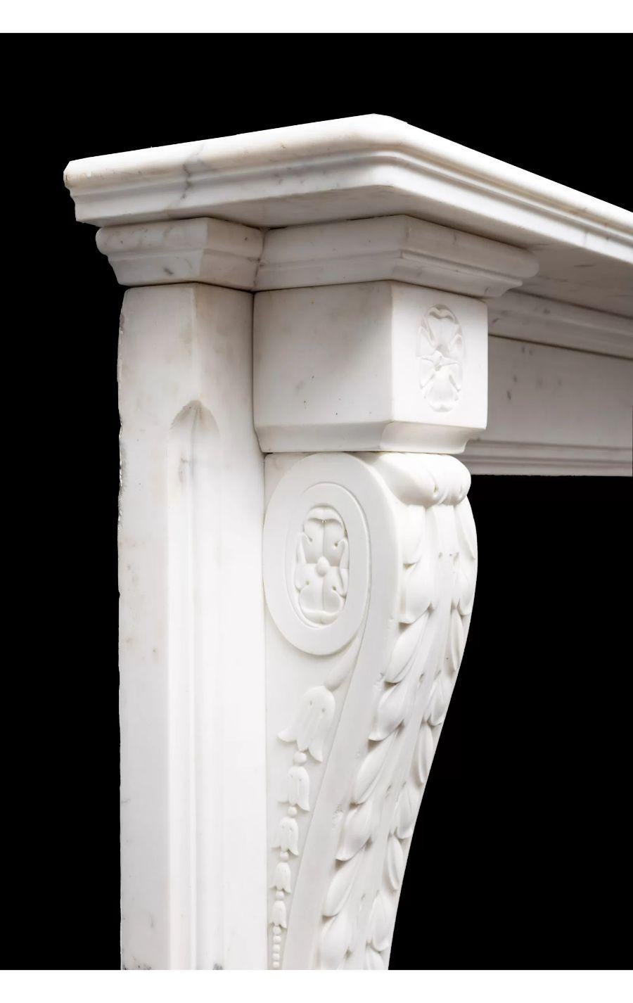 An early 19th century antique Italian white statuary marble fireplace surround.

The consoles beautifully carved with acanthus leaf decoration to the front and bellflowers to the side, these under floral corner blocks.

Circa 1830

Additional