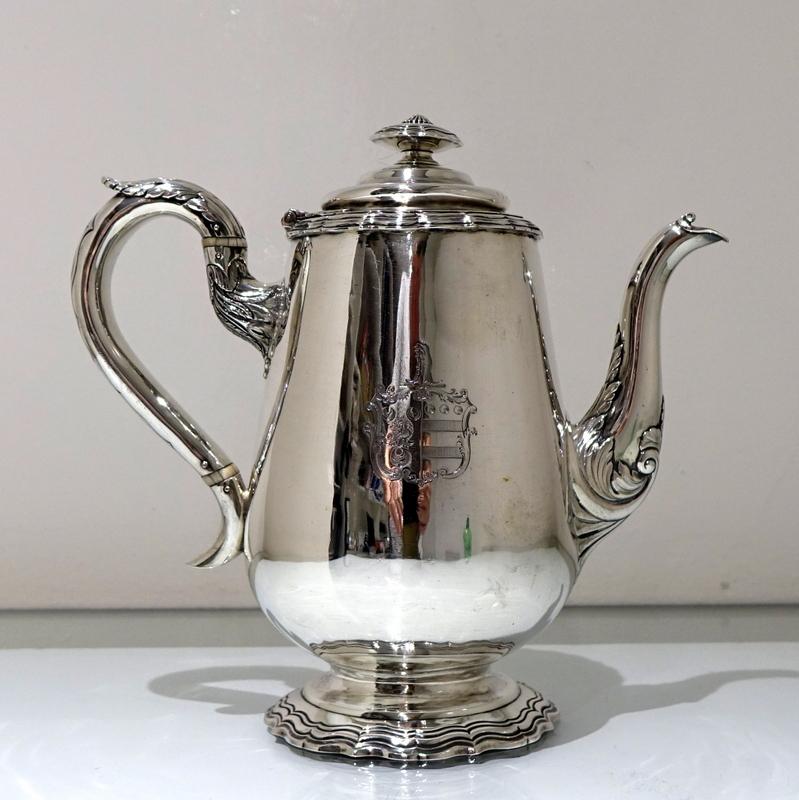 A beautiful and incredibly rare William IV baluster coffee pot designed with an ornate floral spout and an upper socket which forms an elegant decorative contrast to the plain scroll handle. There is a stylish contemporary armorial for