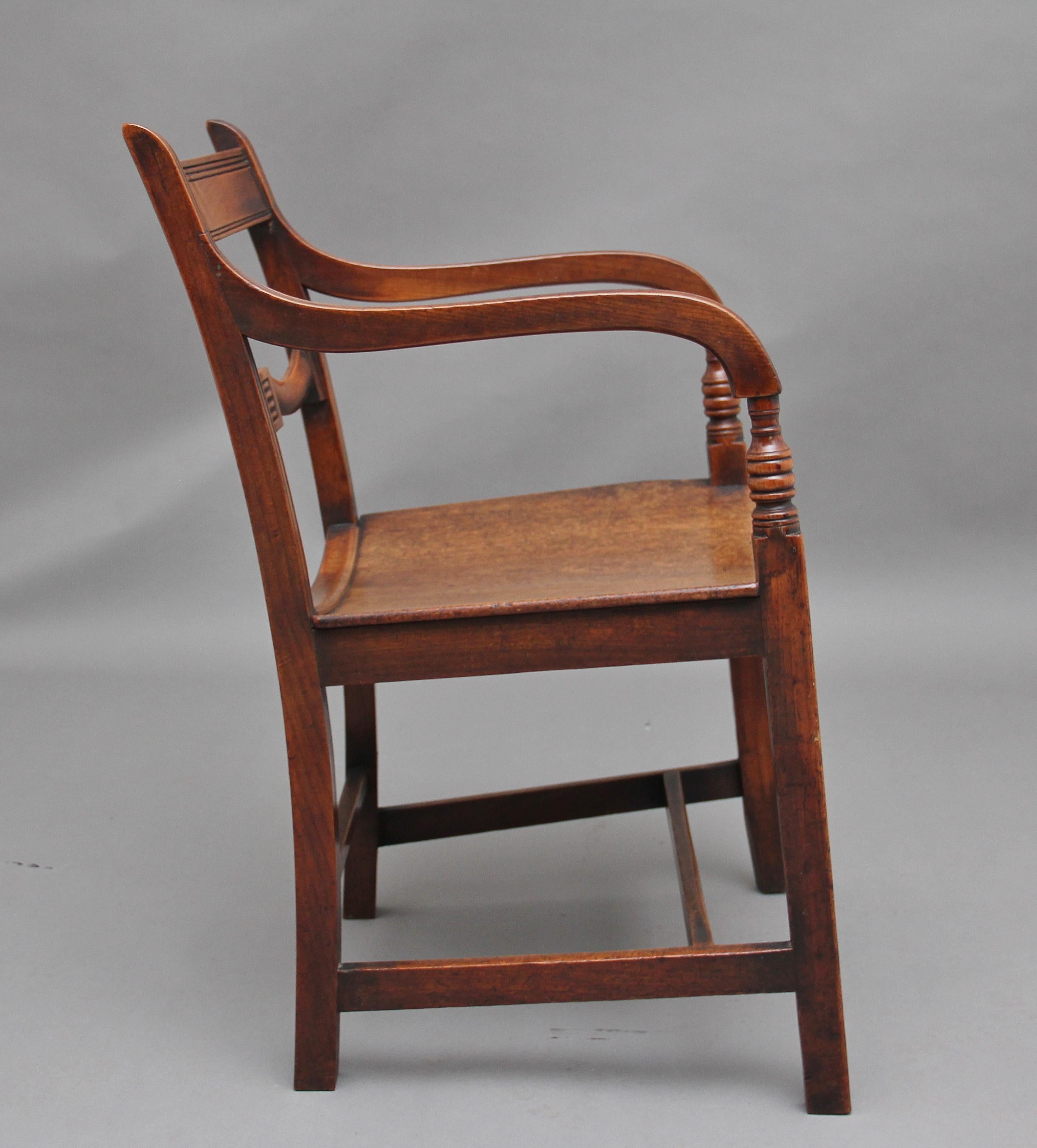 Early 19th century ash and elm armchair, having a reeded top rail and shaped central rail, wonderfully shaped arms with turned supports, curved hard wood seat, supported on square legs united by side, back and front stretchers, circa 1830.