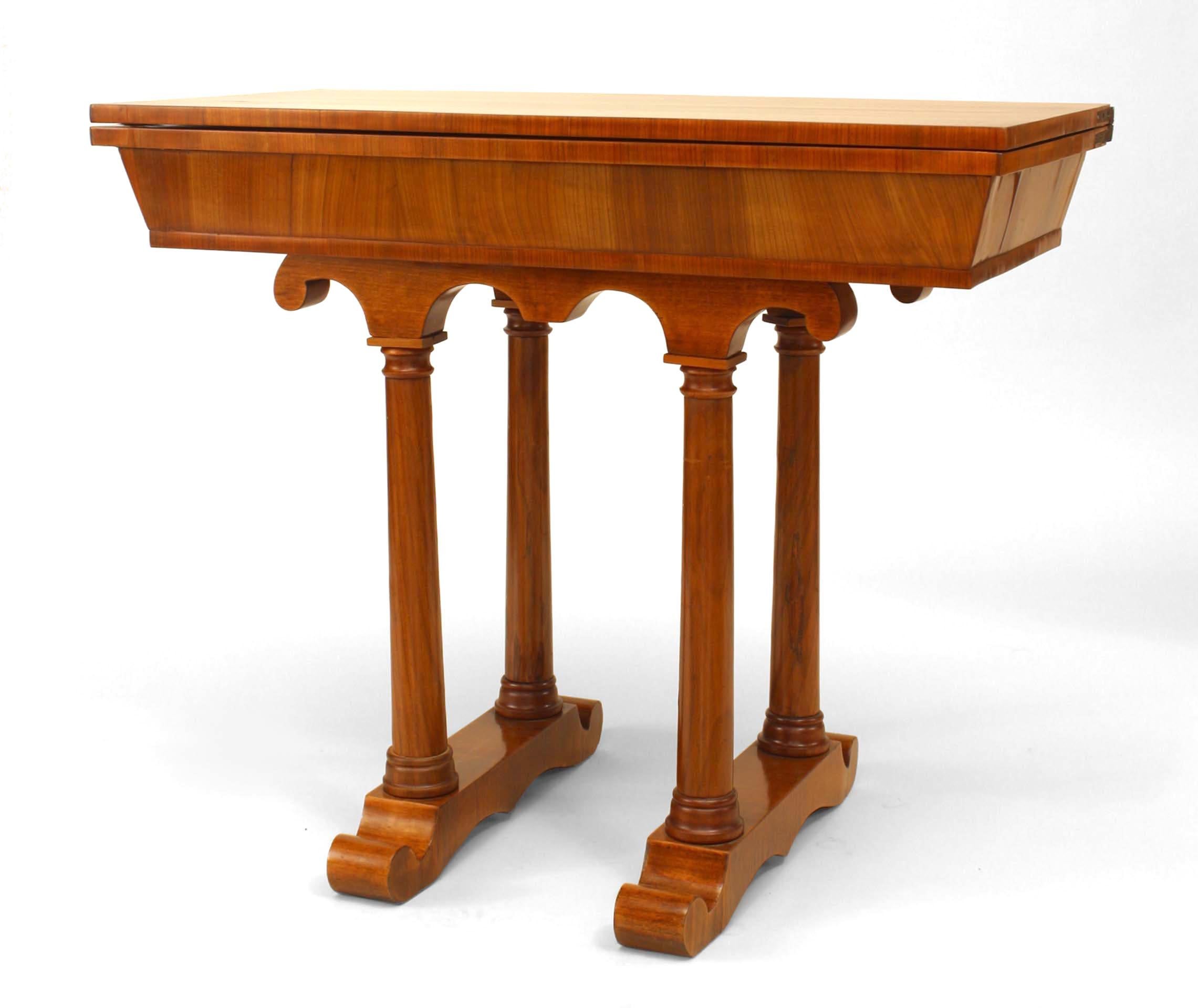 Austrian Biedermeier cherrywood console or flip top game table dating to the second quarter of the nineteenth century. The piece features double column design pedestals supported on a rectangular base. When opened, it shows a green felt game top.