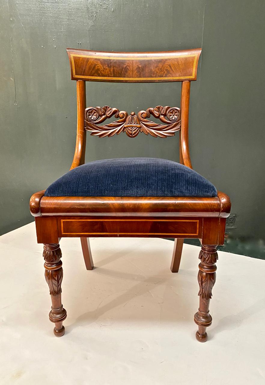 This is a superb example of a solid mahogany carved and inlaid Danish or Baltic side chair of Klismos form. The chair has been refinished at some point. The quality of the carving, inlay and perfect form make this a highly desirable neoclassical