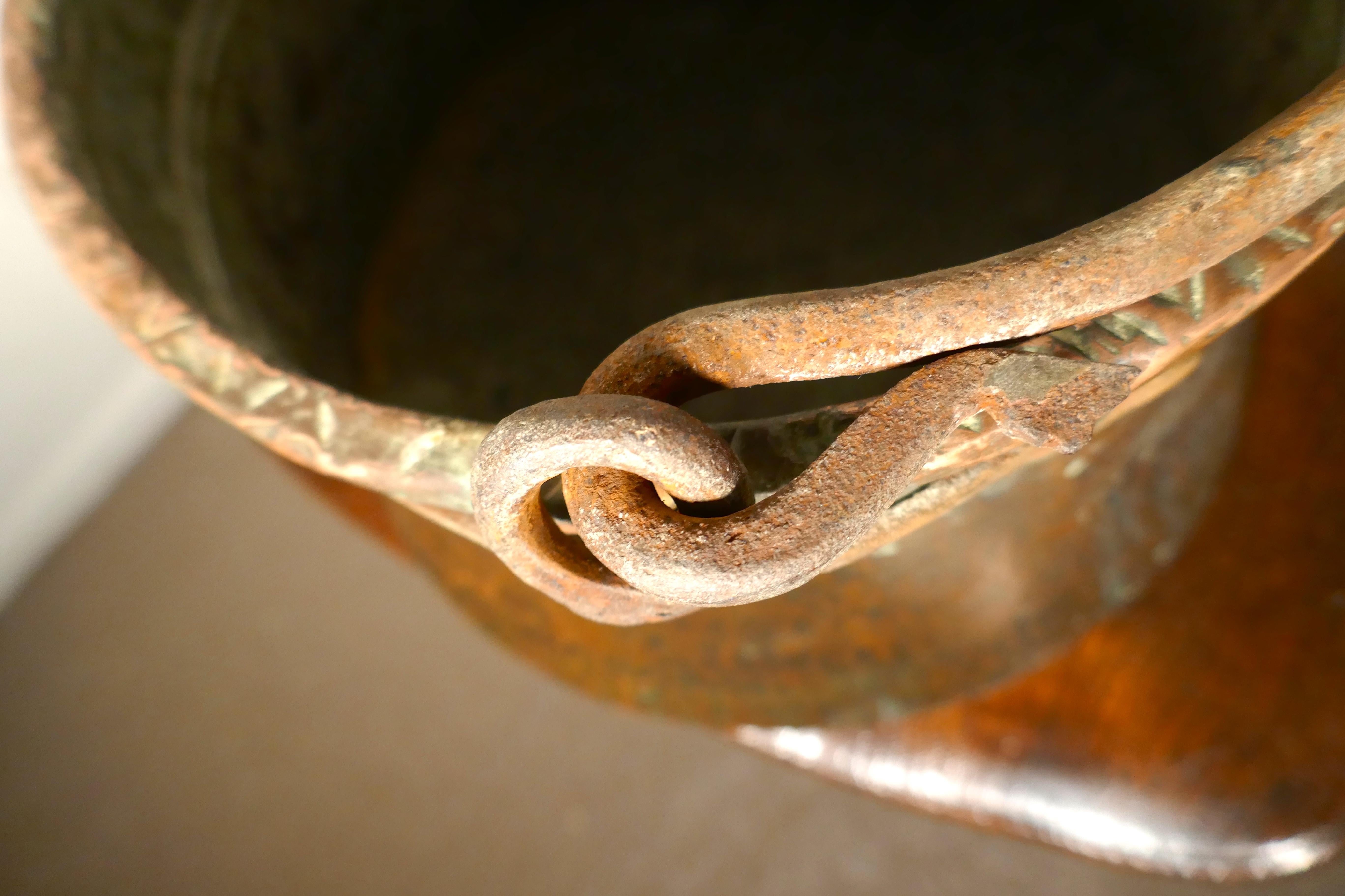Early 19th century beaten copper cooking pot, cauldron

This is a lovely early cooking pot, it is made in beaten copper, slightly flaring out at the bottom, to catch the maximum heat from the fire
The pot has a decorated rolled top and the Iron