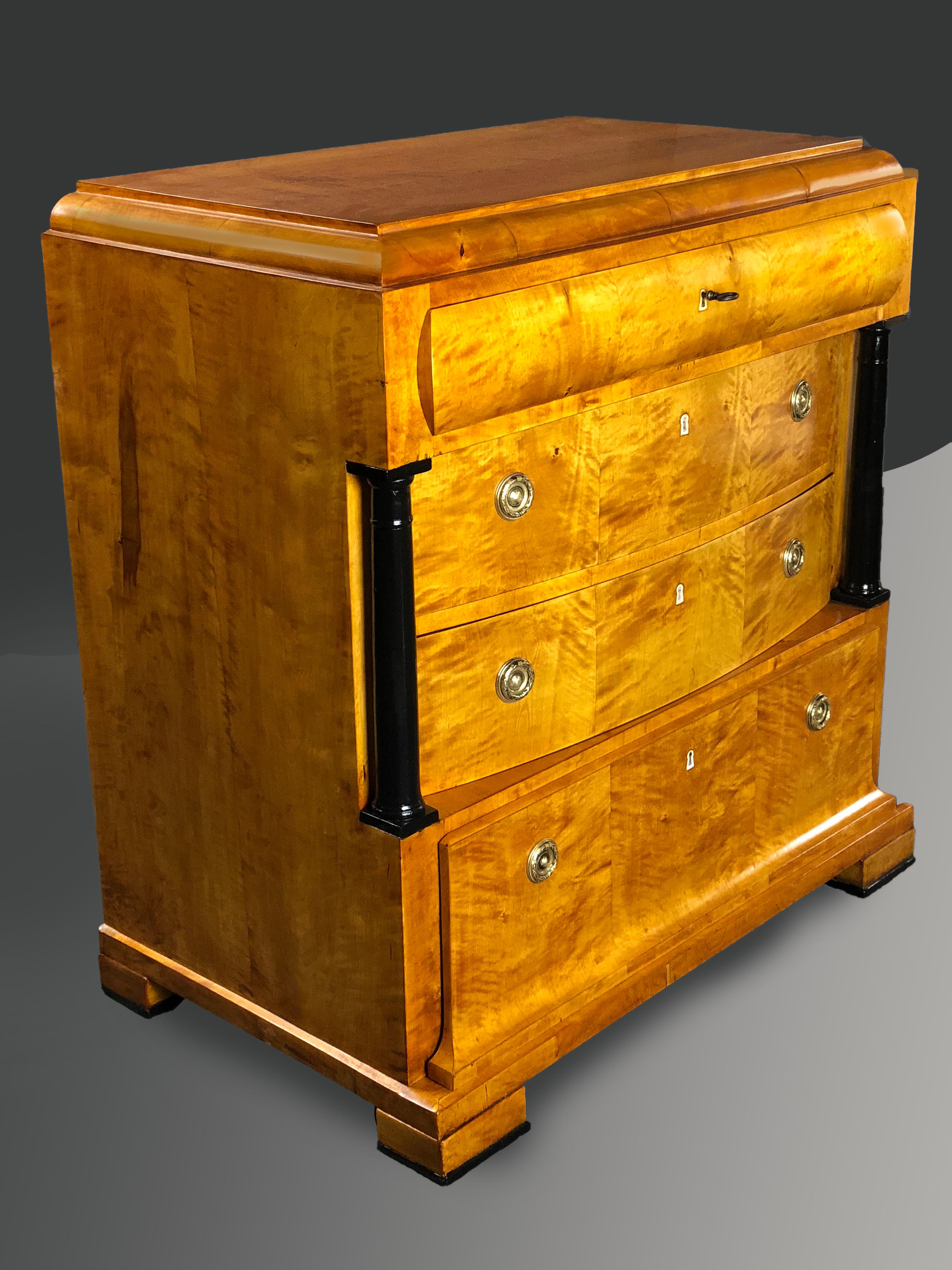 Outstanding Biedermeier late 19th century German finely figured satin birch commode of complex architectural design, the top border ending in curved moulding, the top drawer also having a moulded front, its interior with three divisions. The two bow