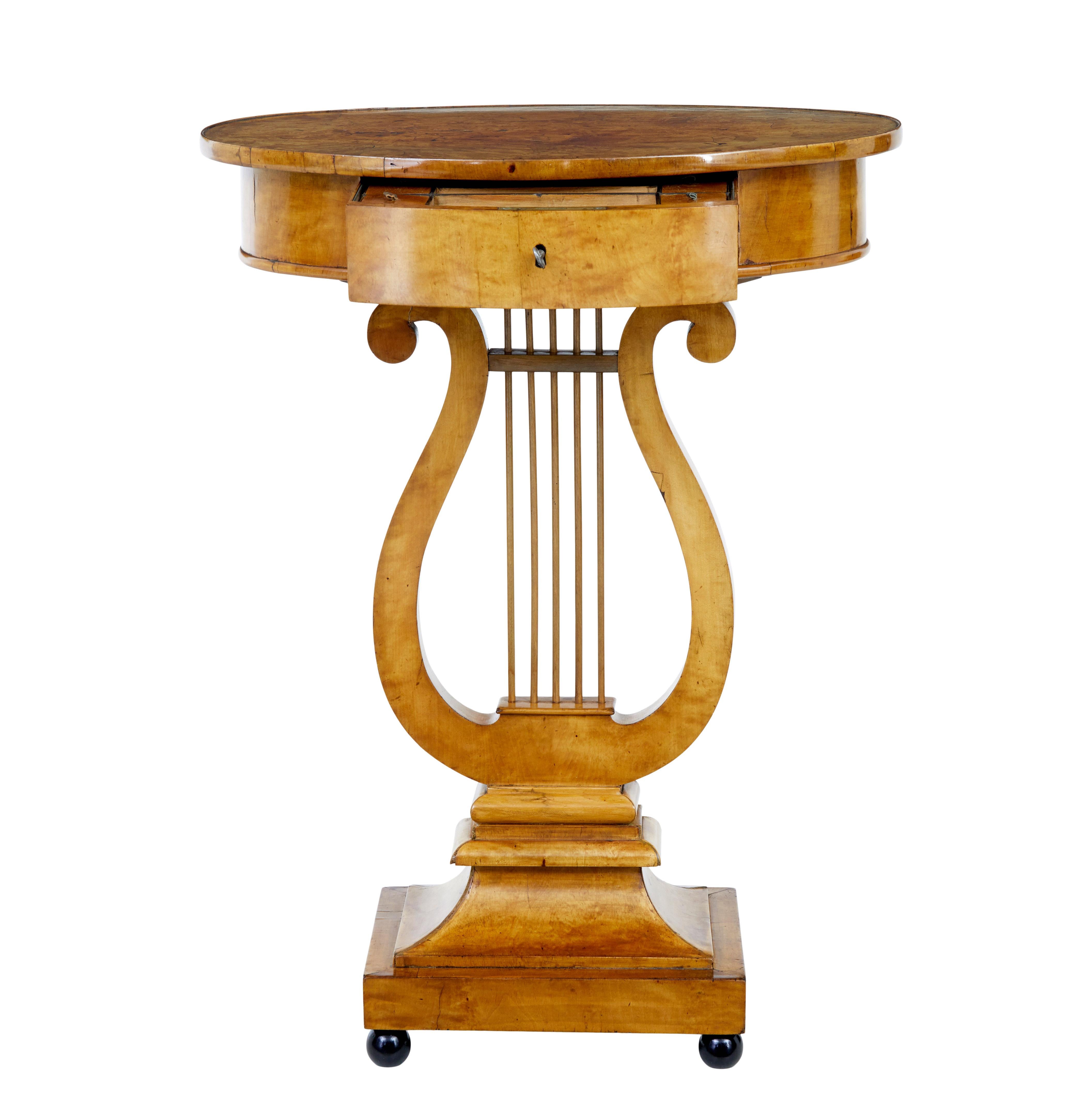Early 19th century birch Empire lyre form side table circa 1820.

Fine quality Swedish Empire period birch side table.

Oval top, veneered in burr birch complete with original moulded edge. Single drawer to the front with working lock and key,