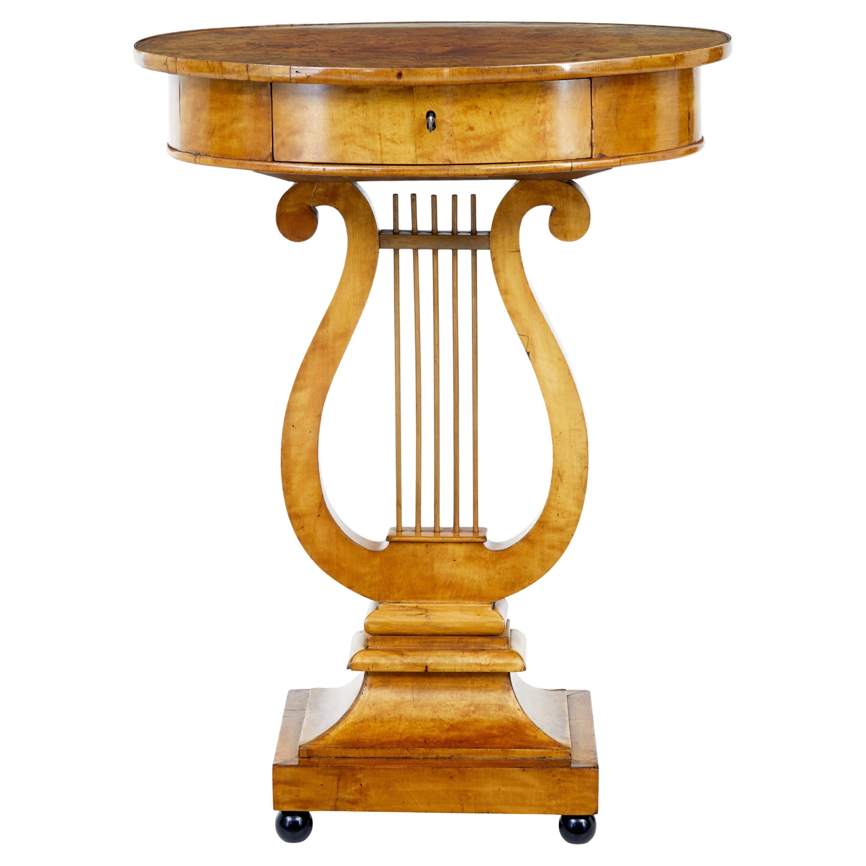 Early 19th century birch empire lyre form side table