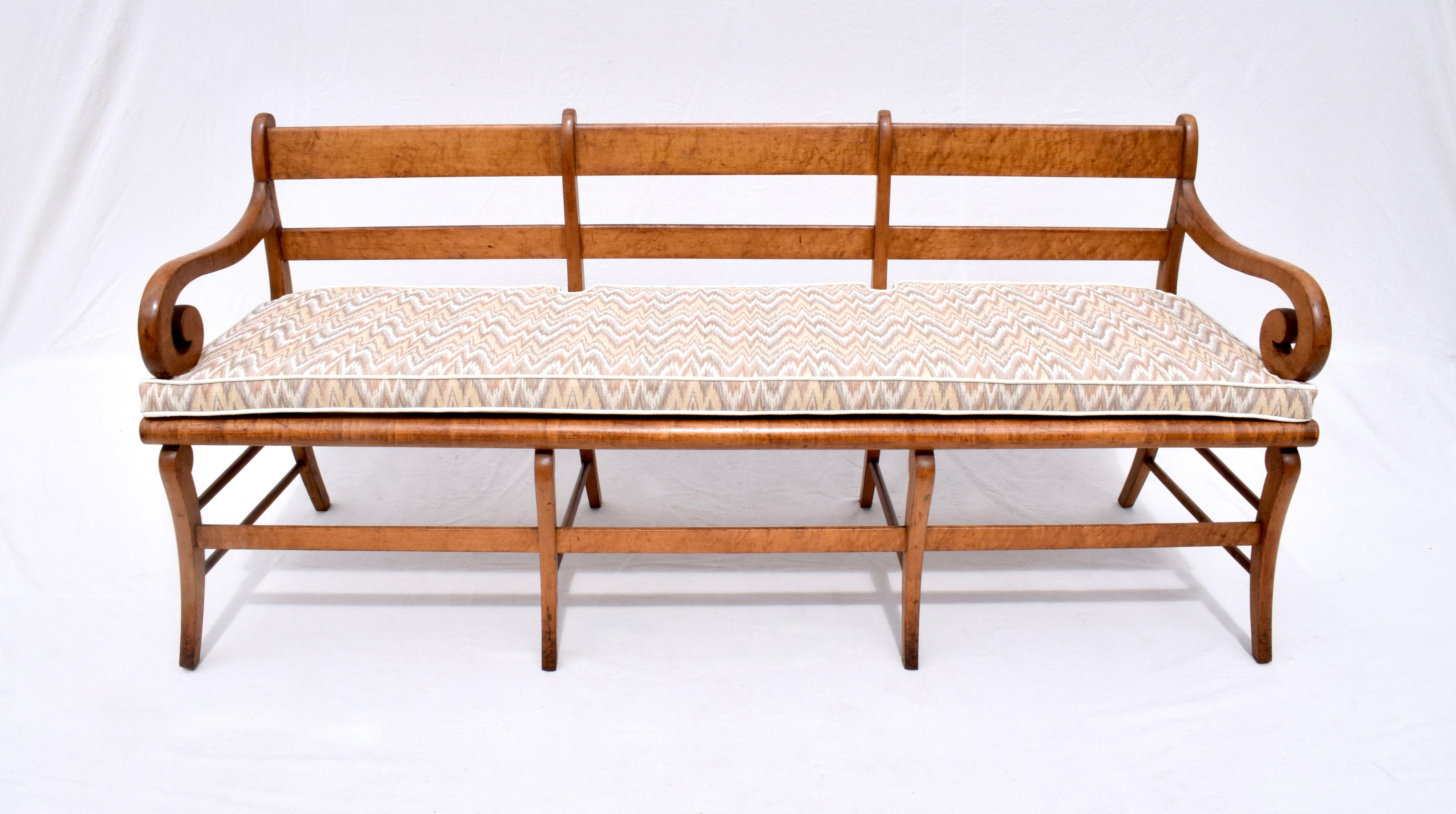 Scarcely seen figured bird’s-eye Maple Sabre leg early 19th century bench c. 1820-1840. Fully hand detailed with solid reinforced joinery, features include substantial French caned seat with new custom notched cushion in flame stitch woven