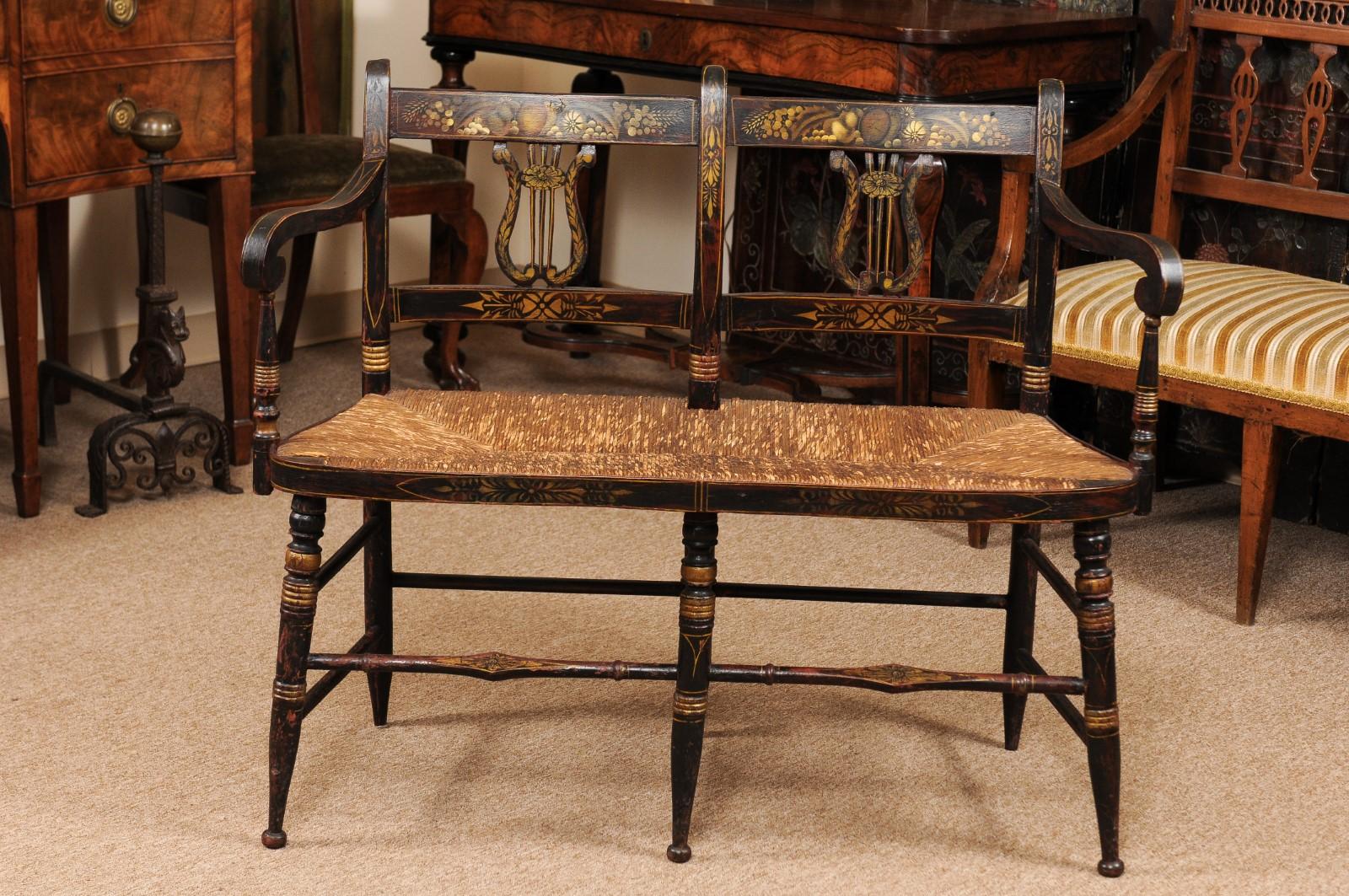 Early 19th Century American black painted bench with lyre-form back-splats & rush seat.