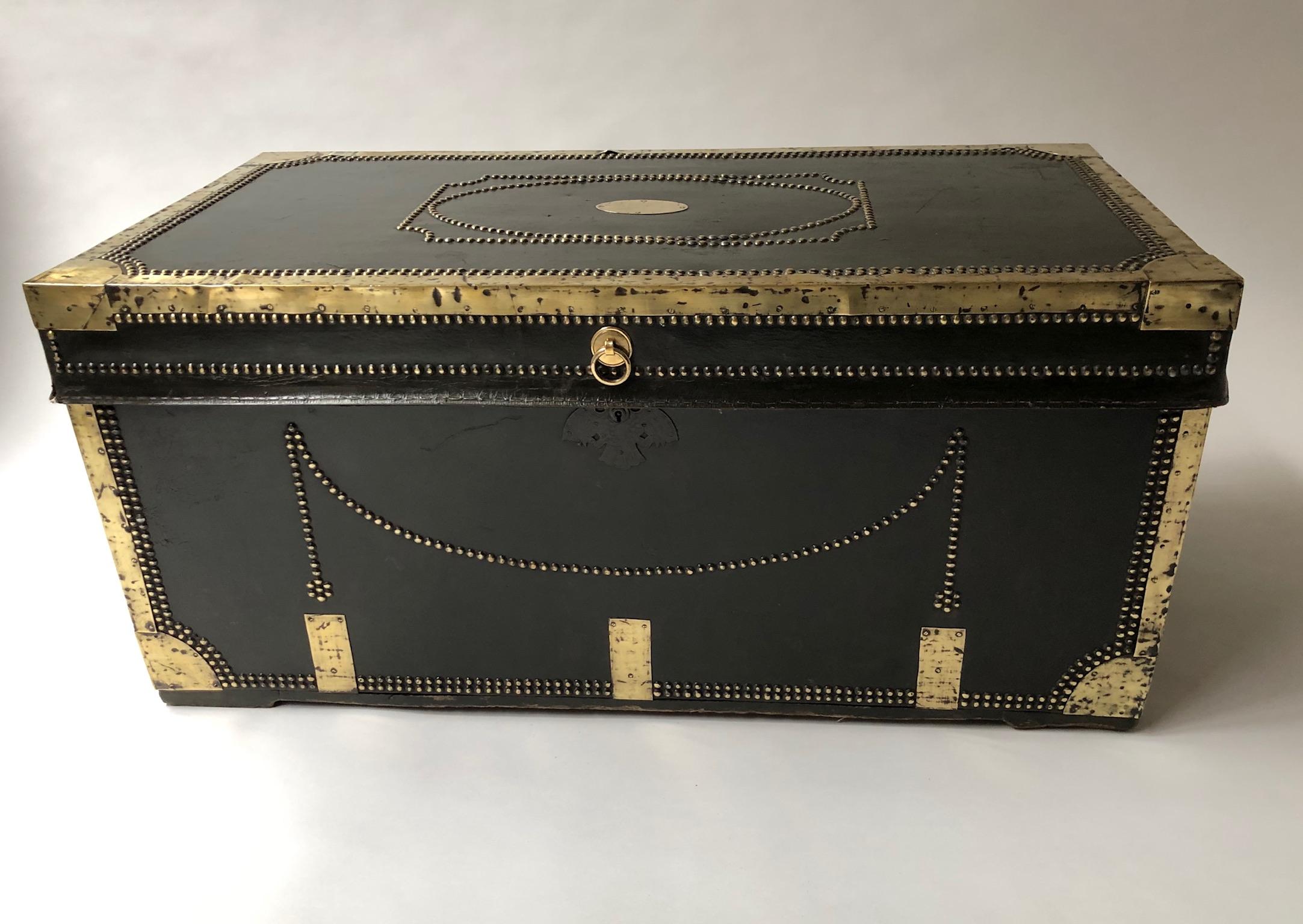 Early 19th century brass bound and studded dark green leather covered camphorwood with rising hinged
lid and side carrying handles
This is an outstanding example of a coaching travelling trunk from the period of horse-drawn stage and post coach