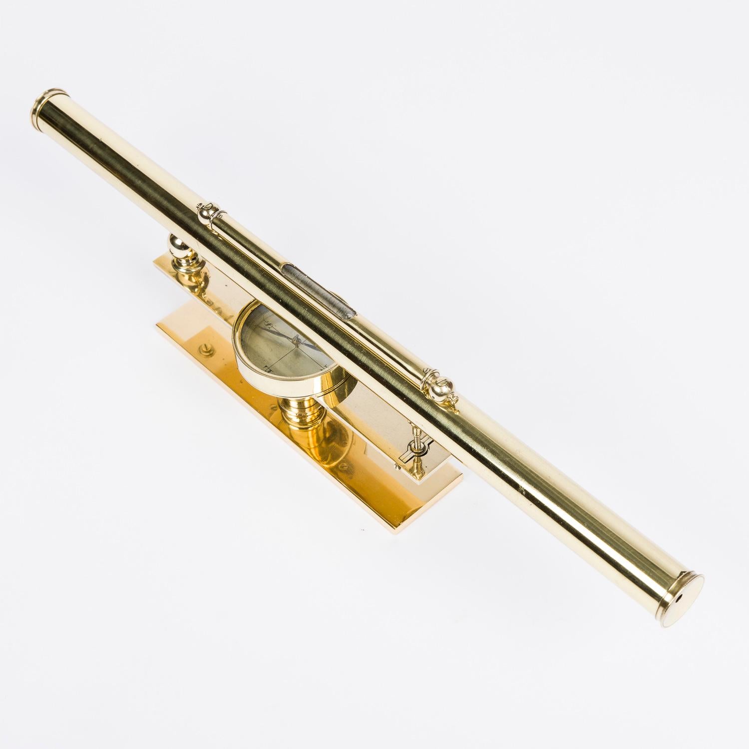 An early 19th century brass surveyor's level with telescope, compass and spirit level.

With original brass mounted pine case.

Telescope length: 18 1/4 inches. - 46.5 cm.

Fitting for tripod mount, now re-mounted on a modern brass plate for desk