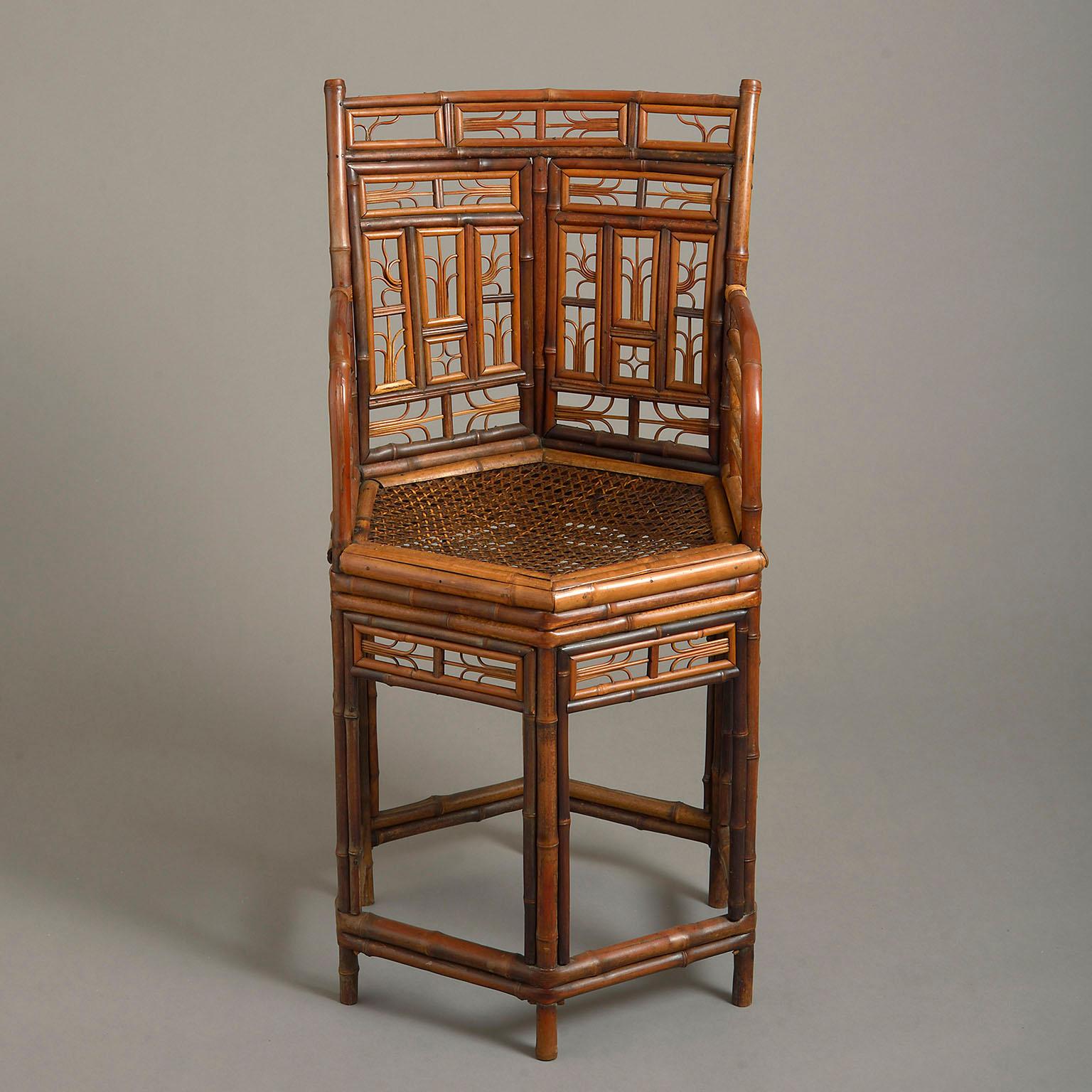 An early 19th century 'Brighton Pavillion' bamboo armchair of unusual hexagonal form, with elaborately trellised back and arms, caned seat and clustered bamboo legs and stretchers.
