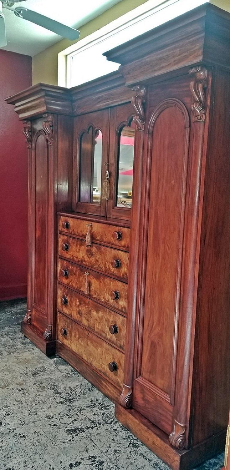 Beautiful early 19th century, circa 1830, William IV Period, mahogany Regency Gothic Revival wardrobe or armoire or linen press with central mirrored tabernacle and 5-drawer chest of drawers. The best way to describe it is as a recessed breakfront