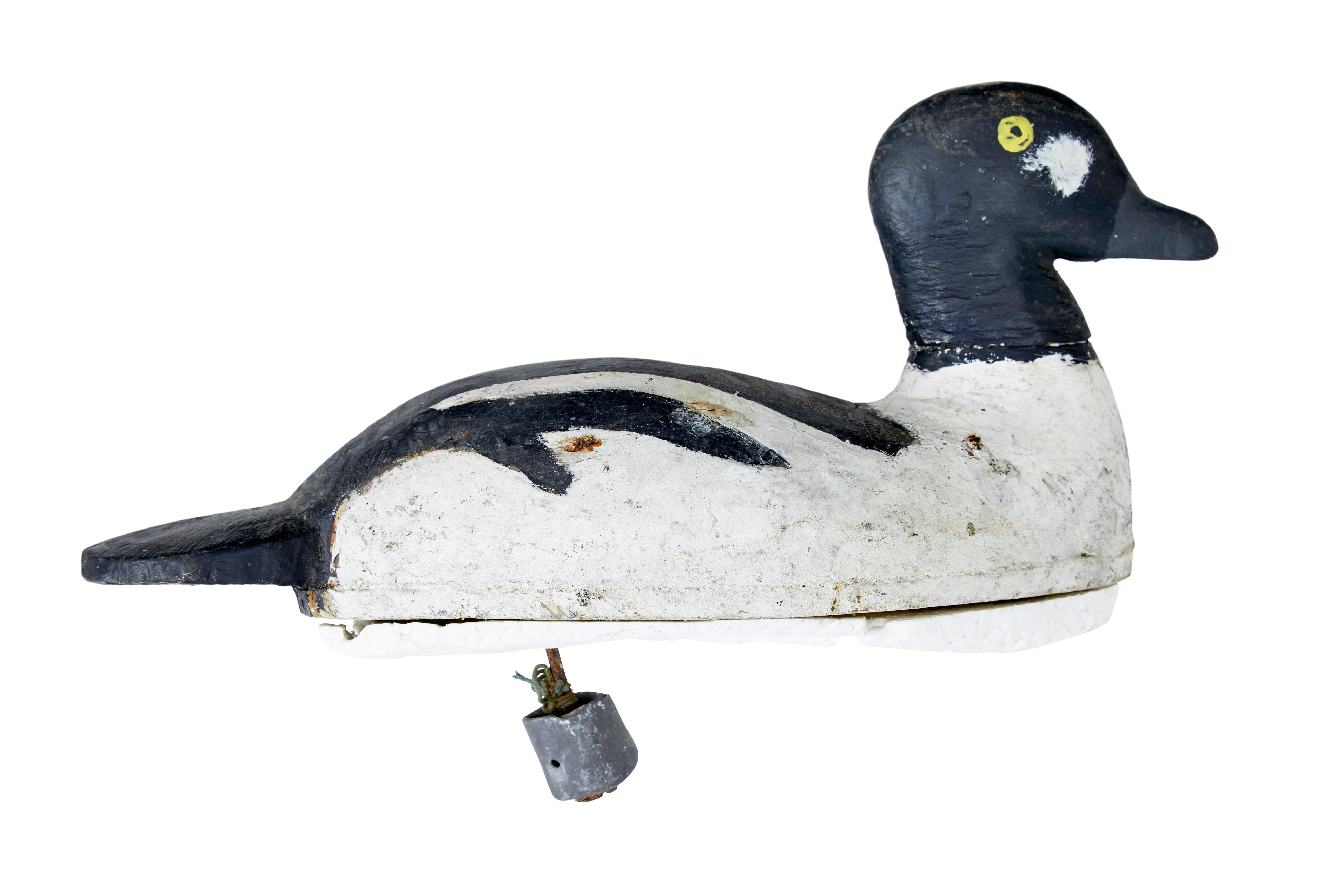 Early 19th century carved hand painted decoy circa 1920.

Hand painted Scandinavian decoy duck, black and white paint scheme with yellow eyes. Later fitted with shaped polysterene float and lead weight.

Expected paint losses and wear.