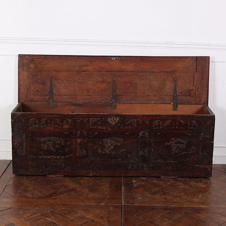 A late 18th - early 19th century carved walnut coffer with dovetail joined corners and brass carrying handles. The front is carved in an unusual 'silhouette' style featuring animals and trees. Likely European- probably English. 



 