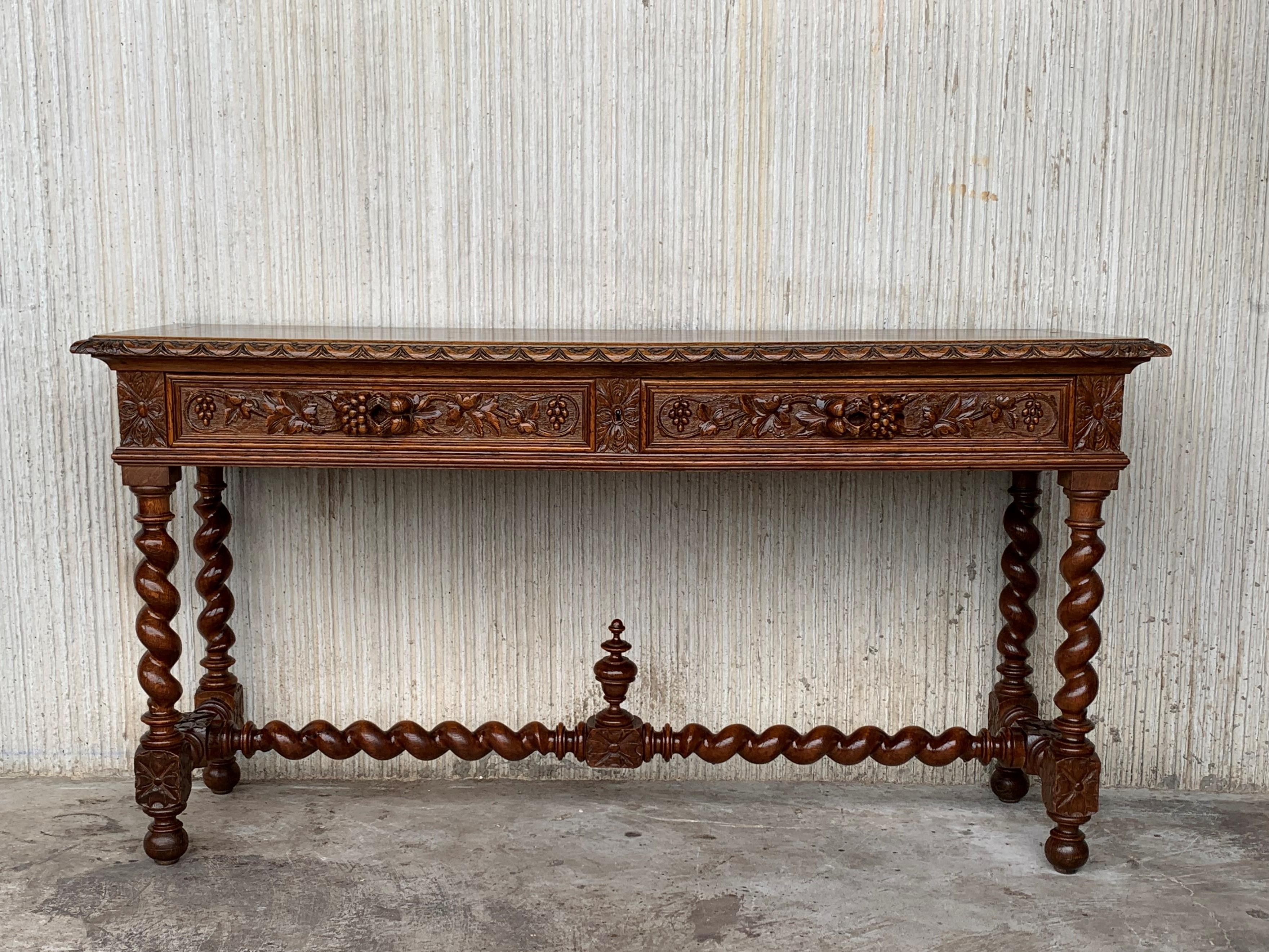 A 19th century walnut console table with a slab top above a frieze with two drawers with front decorated with carved geometrical motifs and incised with additional decoration and a single unusual carved wood pull in each drawer. The table is