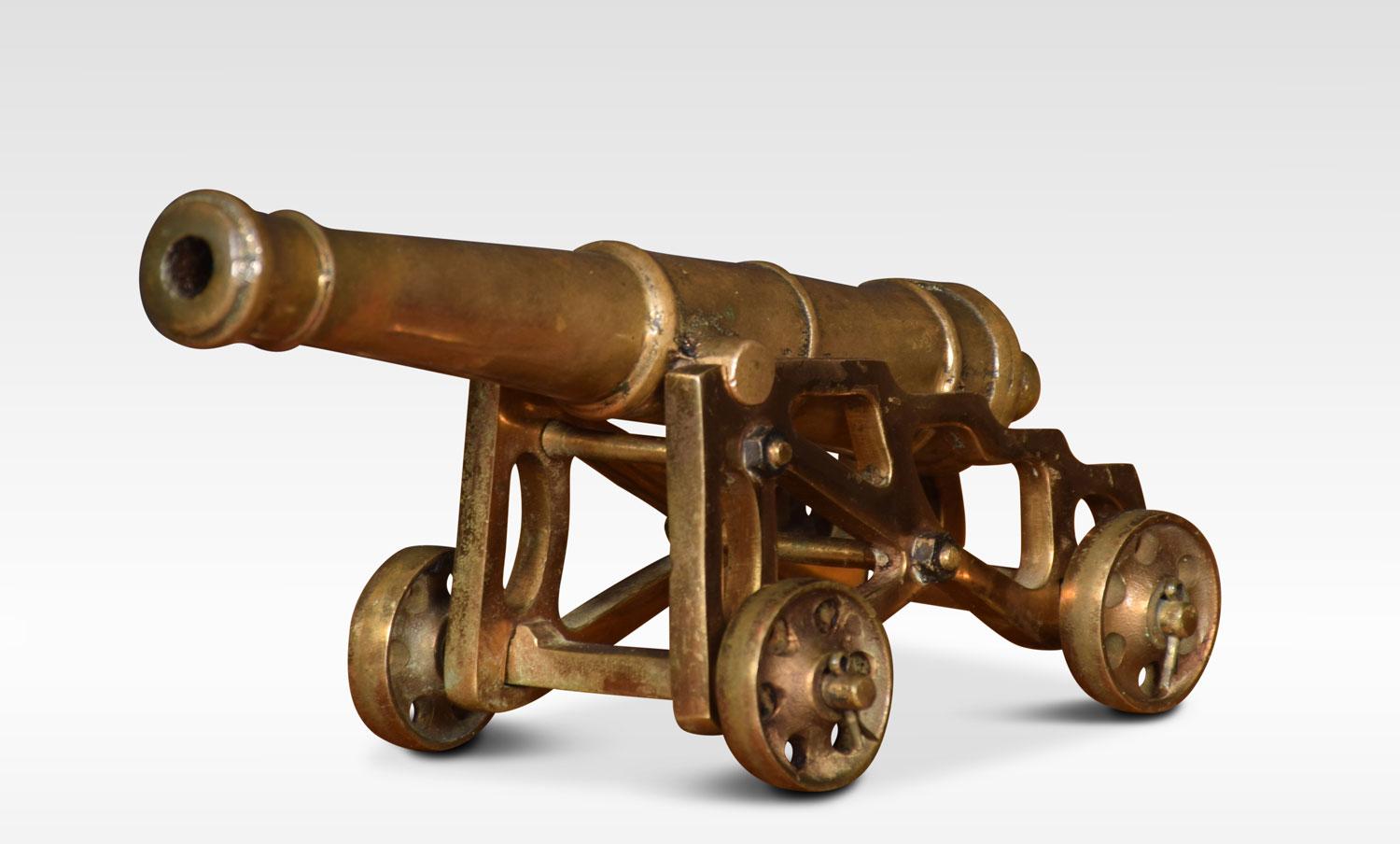 Early 19th century cast brass desk cannon having four wheel openwork garrison carriage.
Dimensions
Height 4.5 inches
Length 9 inches
Width 4.5 inches.