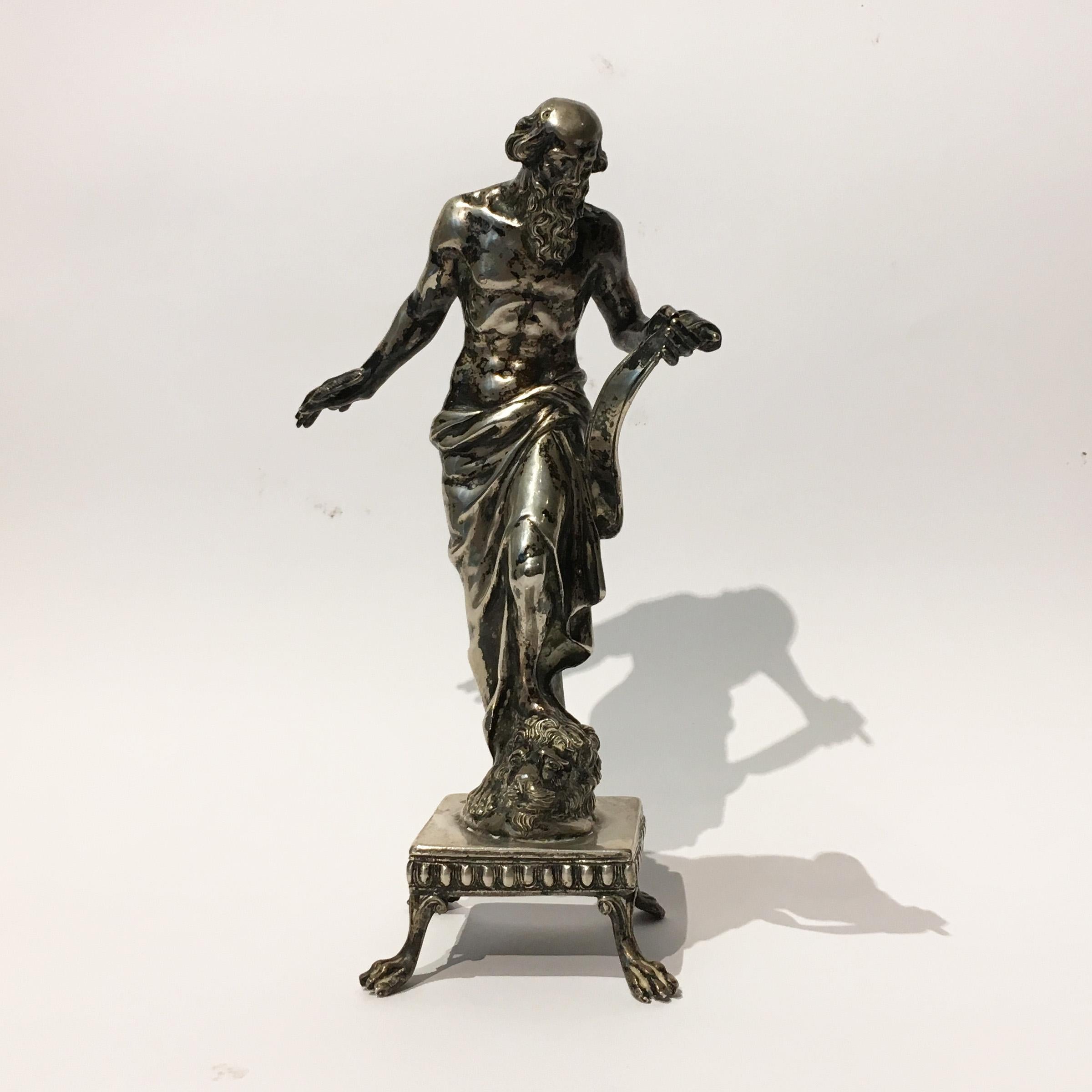 This elegant sculpture depicts Saint Jerome holding a scroll and a feather, with the head of a lion.
The figure stands on a square base with paw feet and presents marks.
Central Italy, early 19th century.