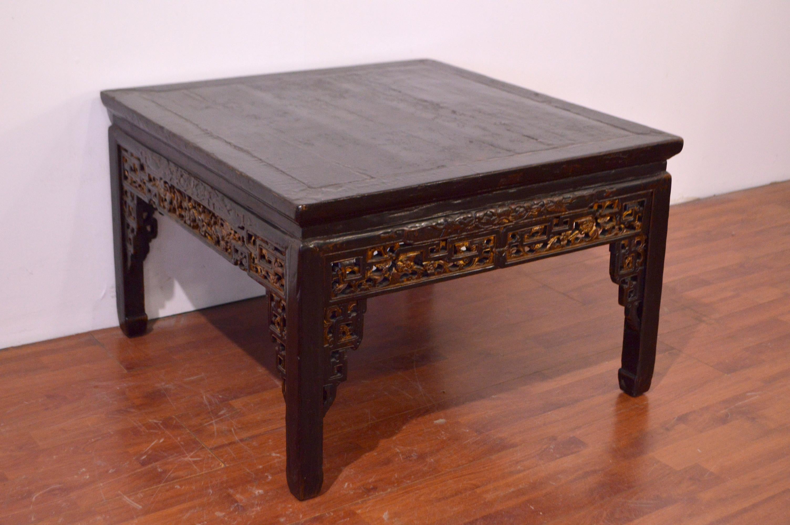 Black laquered chinese coffe table. Precious hand-carved and gold leaf effect finish.